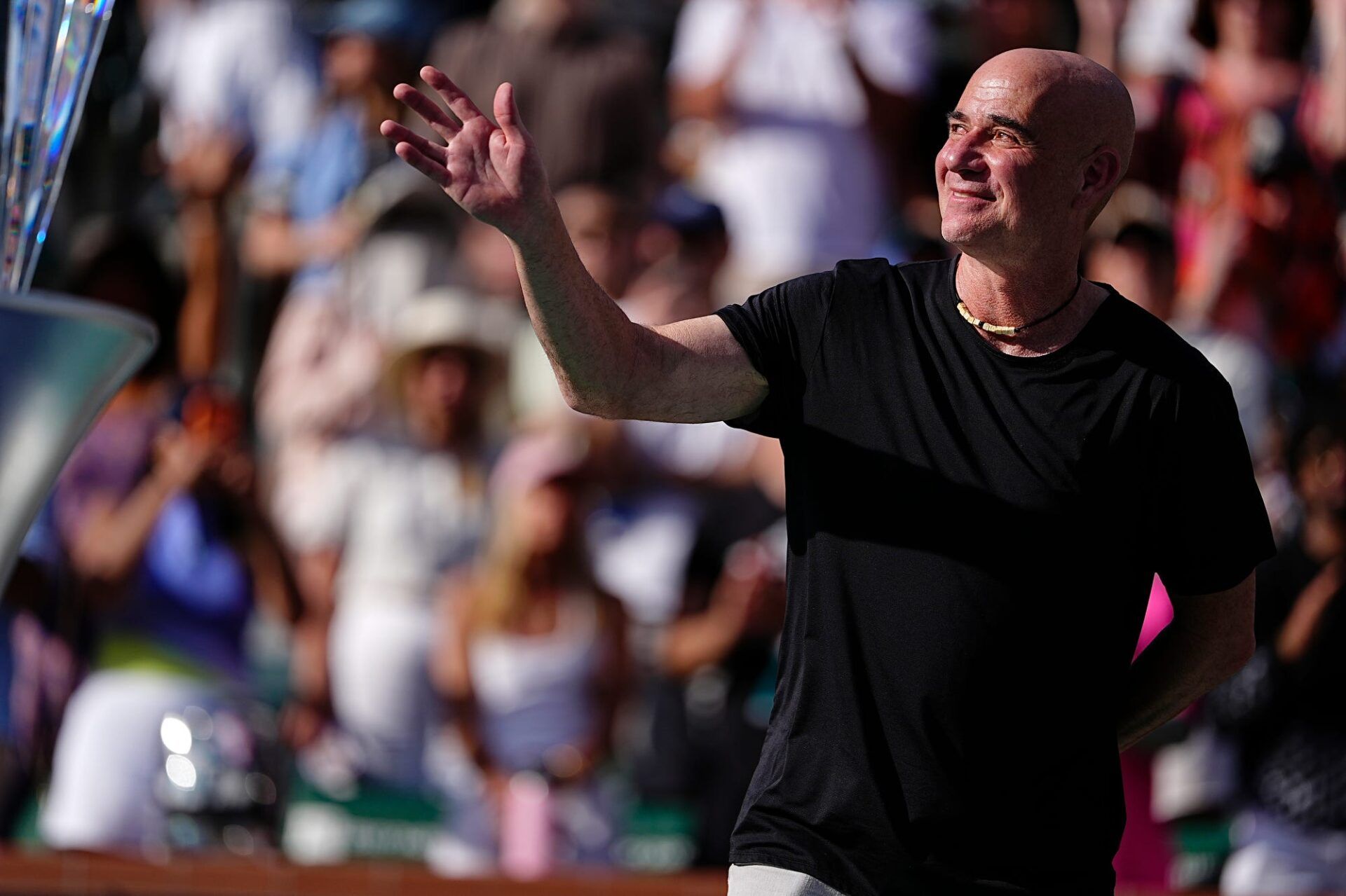 Andre Agassi waves to the crowd during the trophy ceremony for the mens singles final at the BNP Paribas Open in Indian Wells, Calif., on Sunday, March 15, 2026.