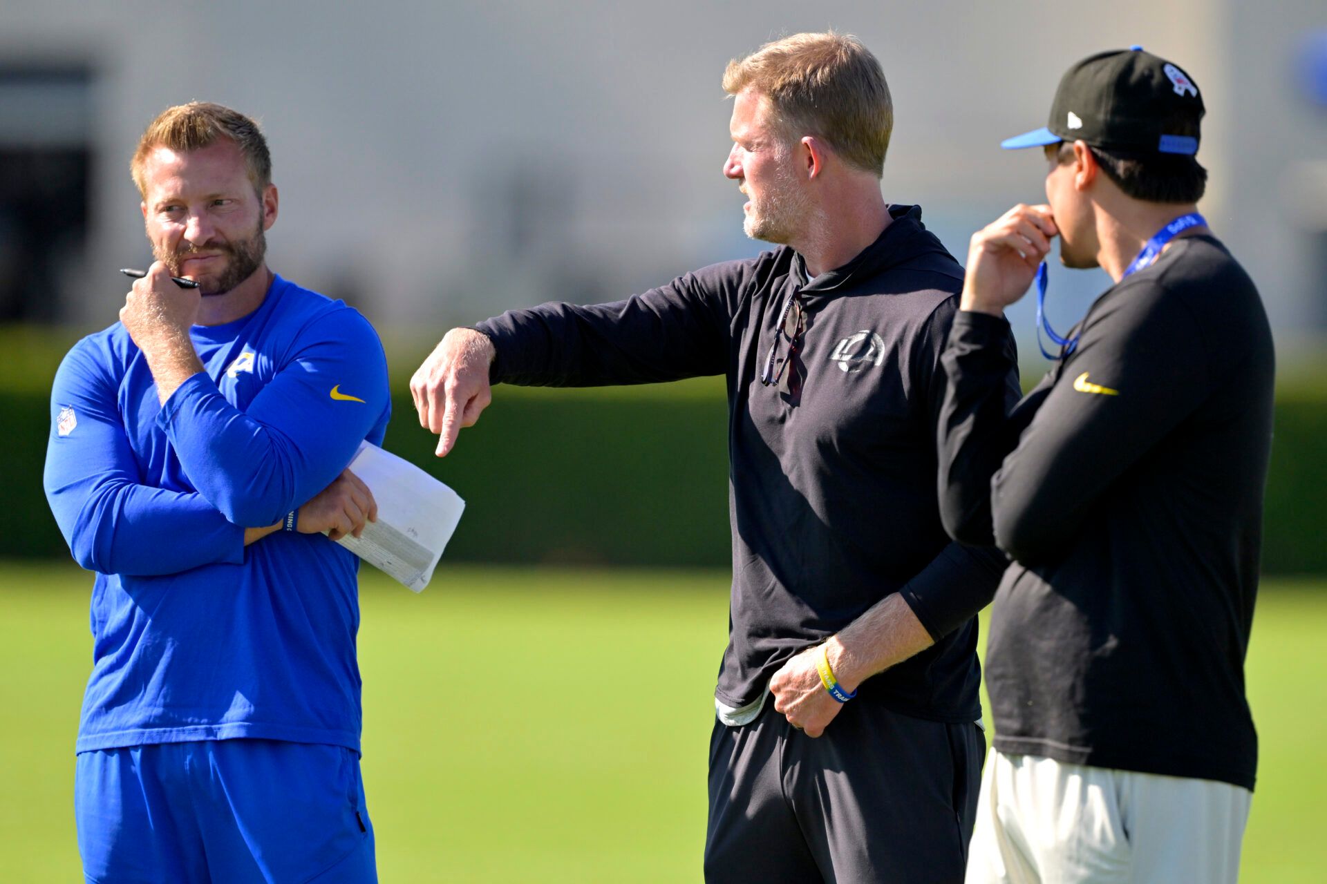 Los Angeles Rams head coach Sean McVay, general manager Les Snead and chief of staff Carter Crutchfield talk on the field during training camp at Loyola Marymount University.