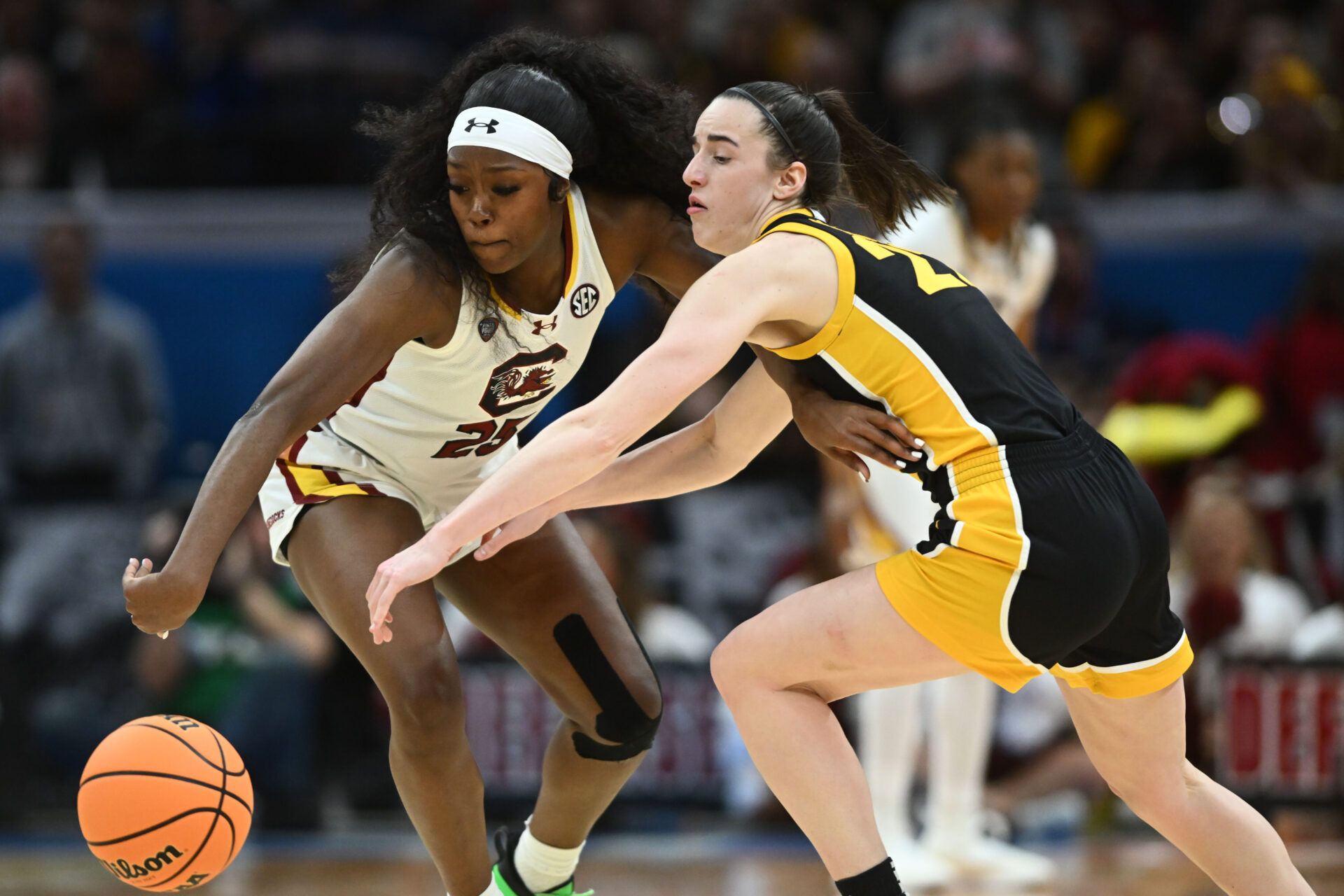 South Carolina Gamecocks guard Raven Johnson (25) steals the ball from Iowa Hawkeyes guard Caitlin Clark (22) in the finals of the Final Four of the womens 2024 NCAA Tournament  at Rocket Mortgage FieldHouse.