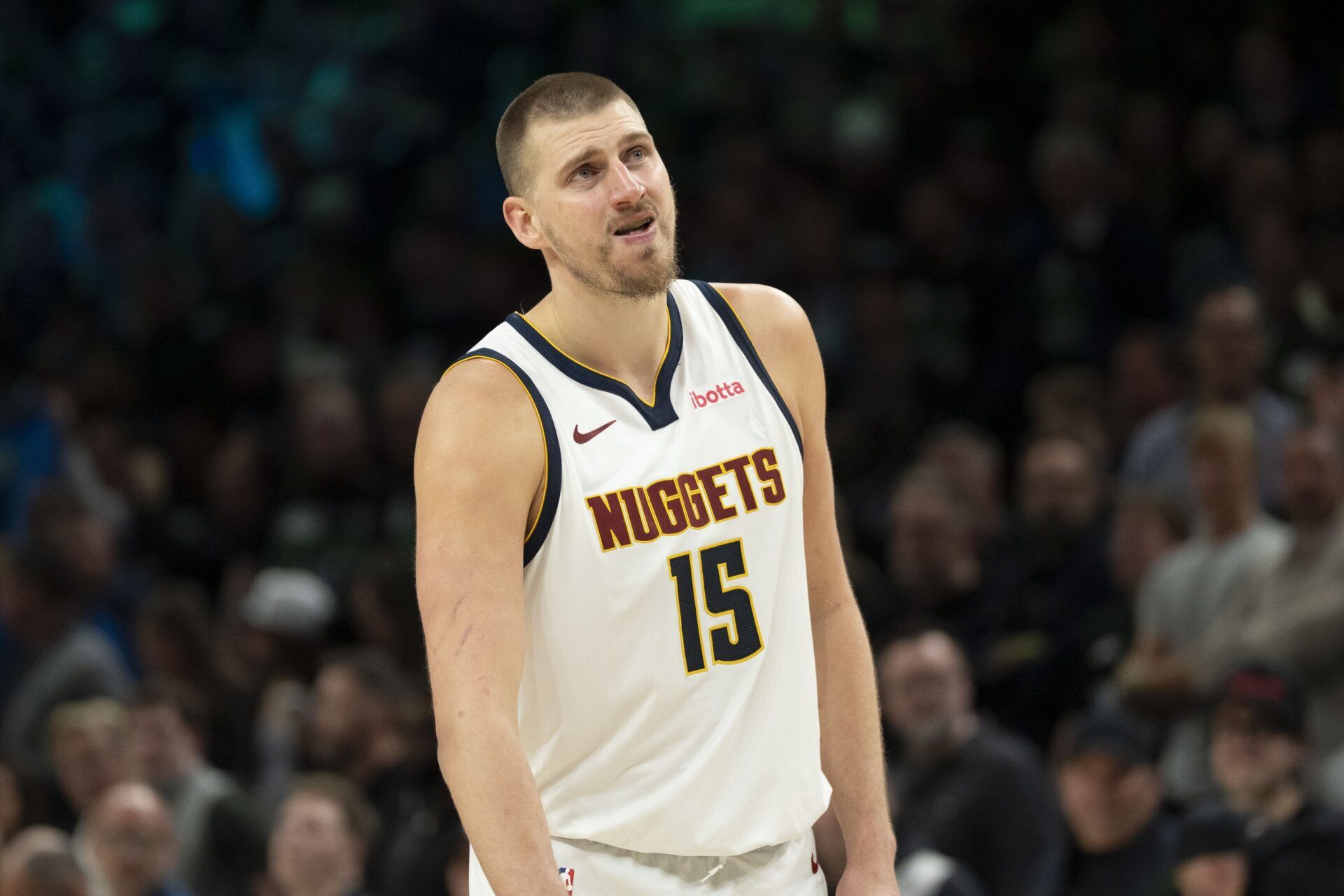 Denver Nuggets center Nikola Jokic (15) looks on against the Minnesota Timberwolves in the second half during game six of the first round of the 2026 NBA Playoffs at Target Center.
