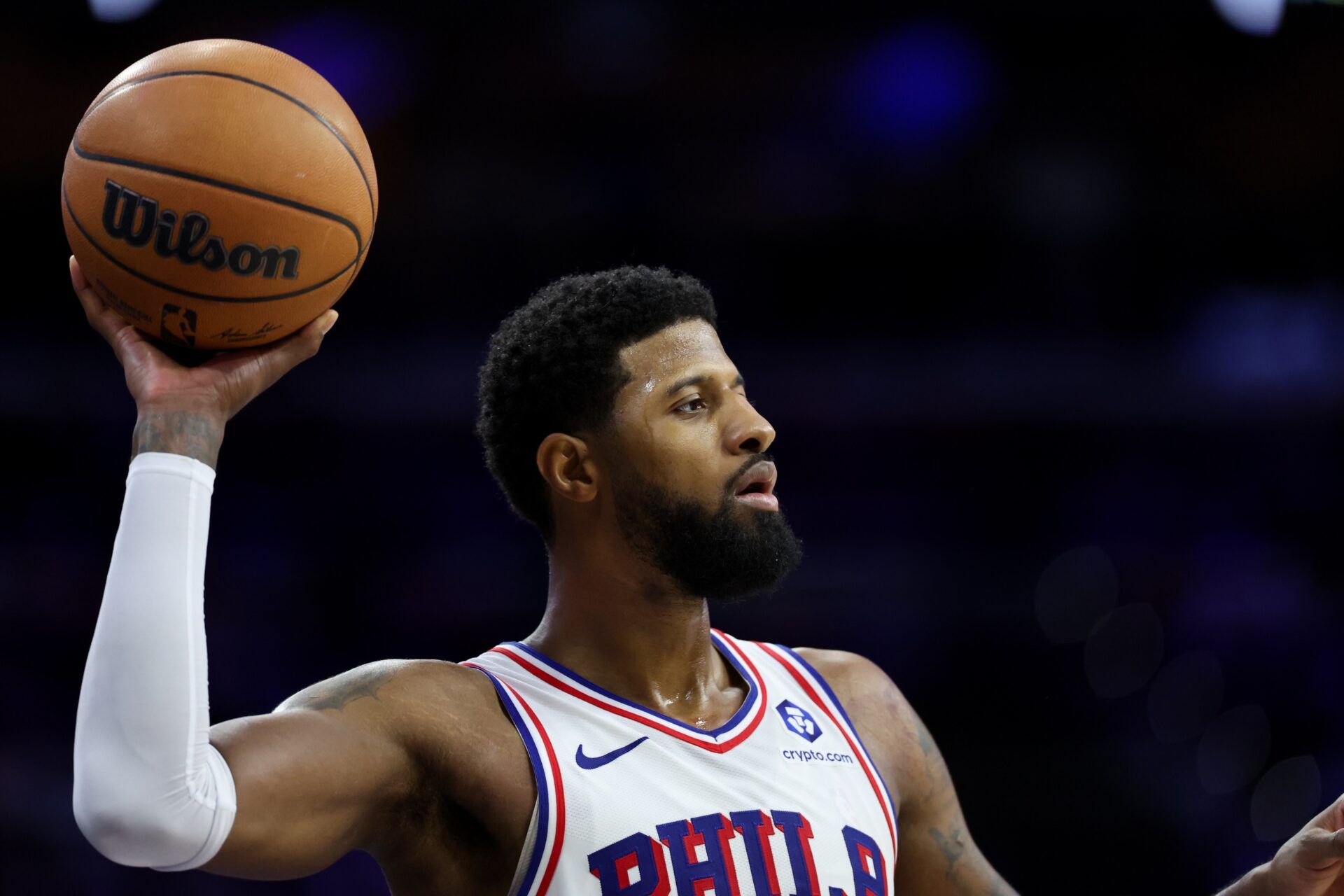 Philadelphia 76ers forward Paul George (8) controls the ball against the Boston Celtics during the fourth quarter at Xfinity Mobile Arena.