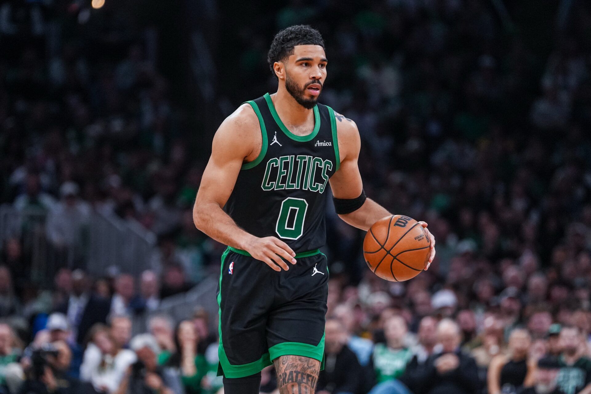 Boston Celtics forward Jayson Tatum (0) returns up court against the Philadelphia 76ers in the second half during game five of the first round of the 2026 NBA Playoffs at TD Garden.