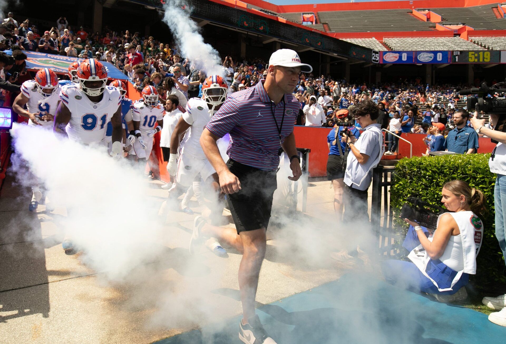 Florida head coach Jon Sumrall and the team blasts out onto the field before the Orange and Blue game at Steve Spurrier Field at Ben Hill Griffin Stadium in Gainesville, FL on Saturday, April 11, 2026. [Alan Youngblood/Gainesville Sun]