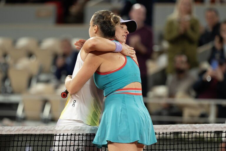 Aryna Sabalenka at the net with  Iga Swiatek of Poland  after their match on day 12 at Roland Garros Stadium.