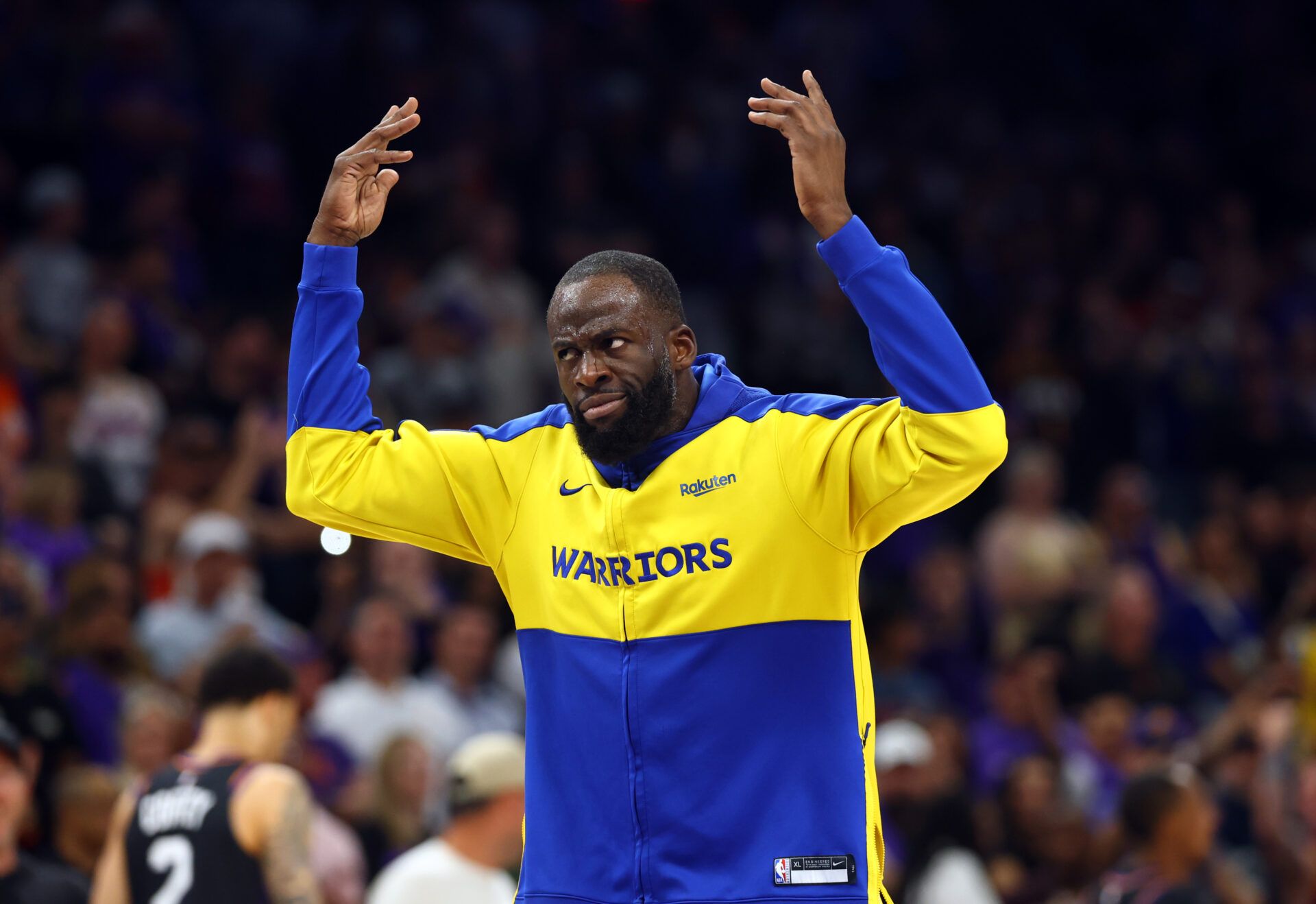 Golden State Warriors forward Draymond Green gestures the crowd after being ejected against the Phoenix Suns during the closing seconds of the play-in rounds of the 2026 NBA Playoffs at Mortgage Matchup Center.