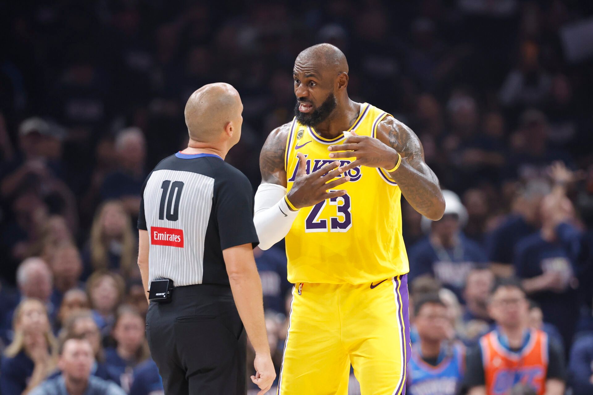 Los Angeles Lakers forward LeBron James (23) talks to referee John Goble (10) after a play against the Oklahoma City Thunder in the first half during game two of the second round of the 2026 NBA Playoffs at Paycom Center.