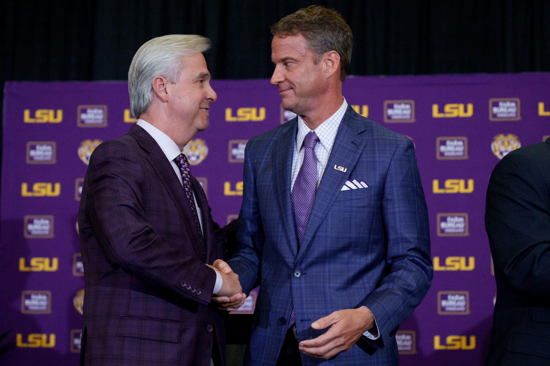 LSU president Wade Rousse, left, and LSU new head coach Lane Kiffin greet each other at South Stadium Club at Tiger Stadium.