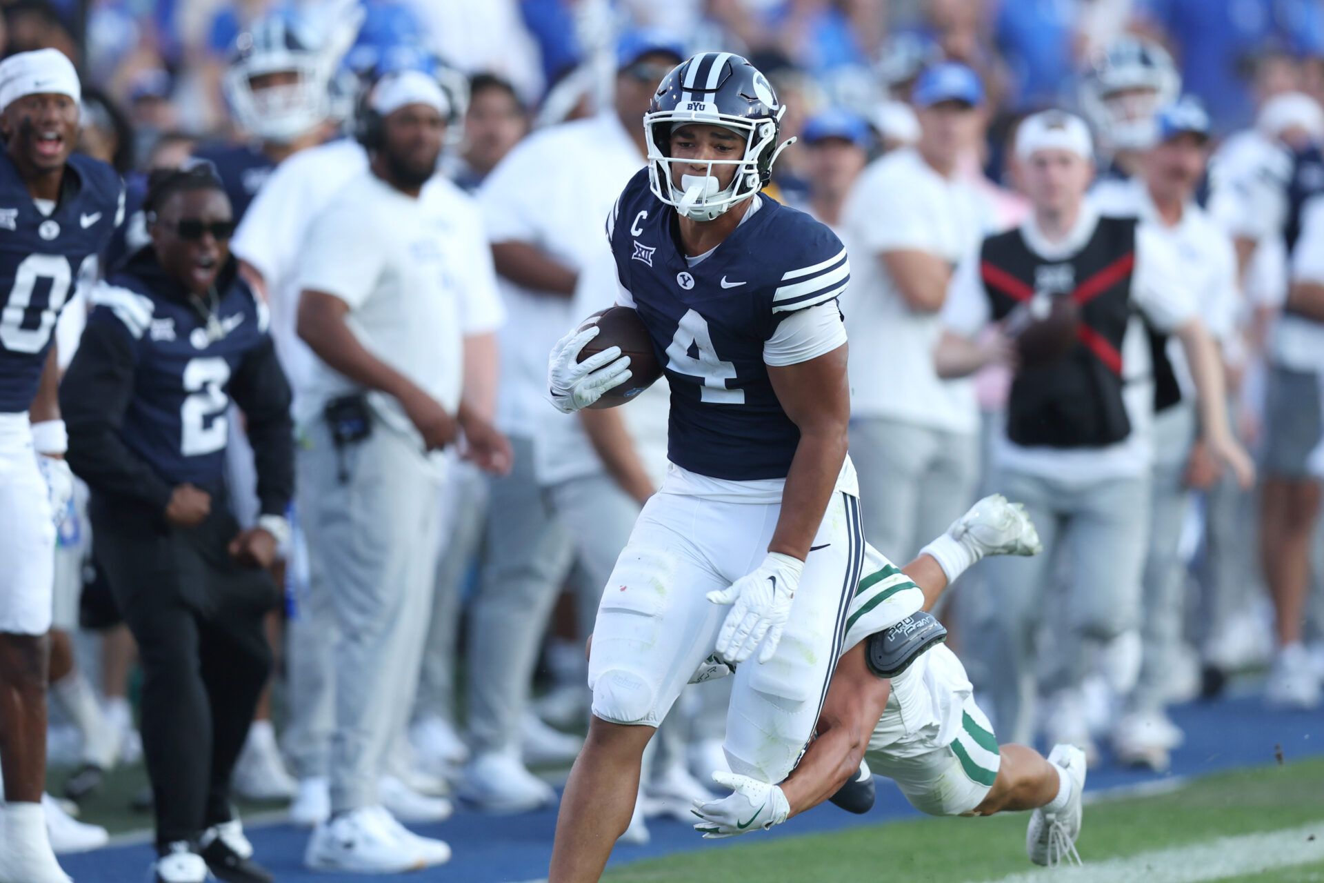 Brigham Young Cougars running back LJ Martin (4) runs the ball against Portland State Vikings linebacker Lonnie Burt (40) during the second quarter at LaVell Edwards Stadium.