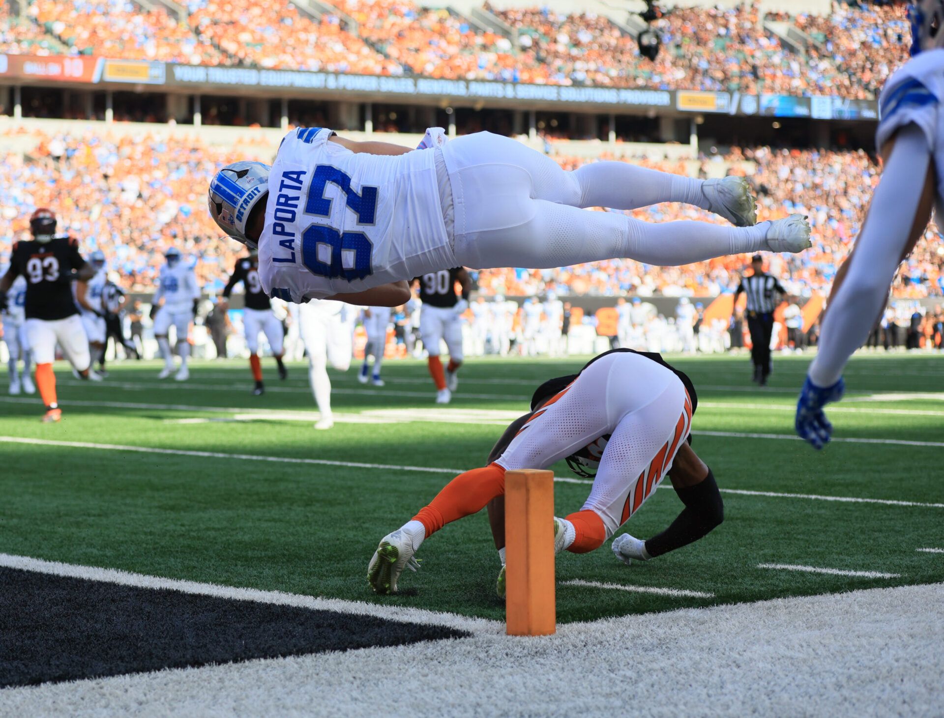 Detroit Lions tight end Sam Laporta (87) flips over Cincinnati Bengals cornerback Daxton Hill (23) for a touchdown during the first quarter at Paycor Stadium.