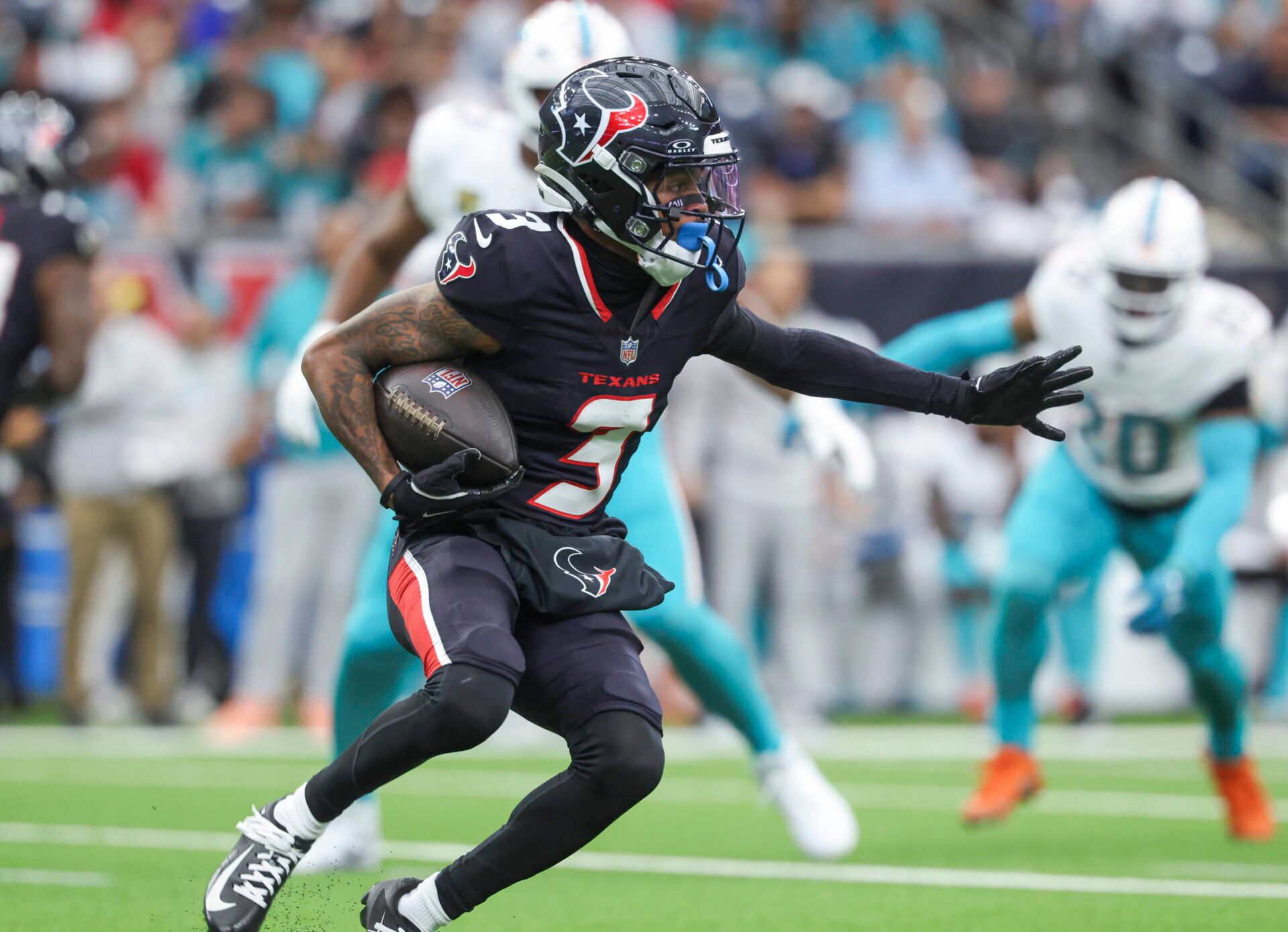 Houston Texans wide receiver Tank Dell (3) runs with the ball during the first quarter against the Miami Dolphins at NRG Stadium.