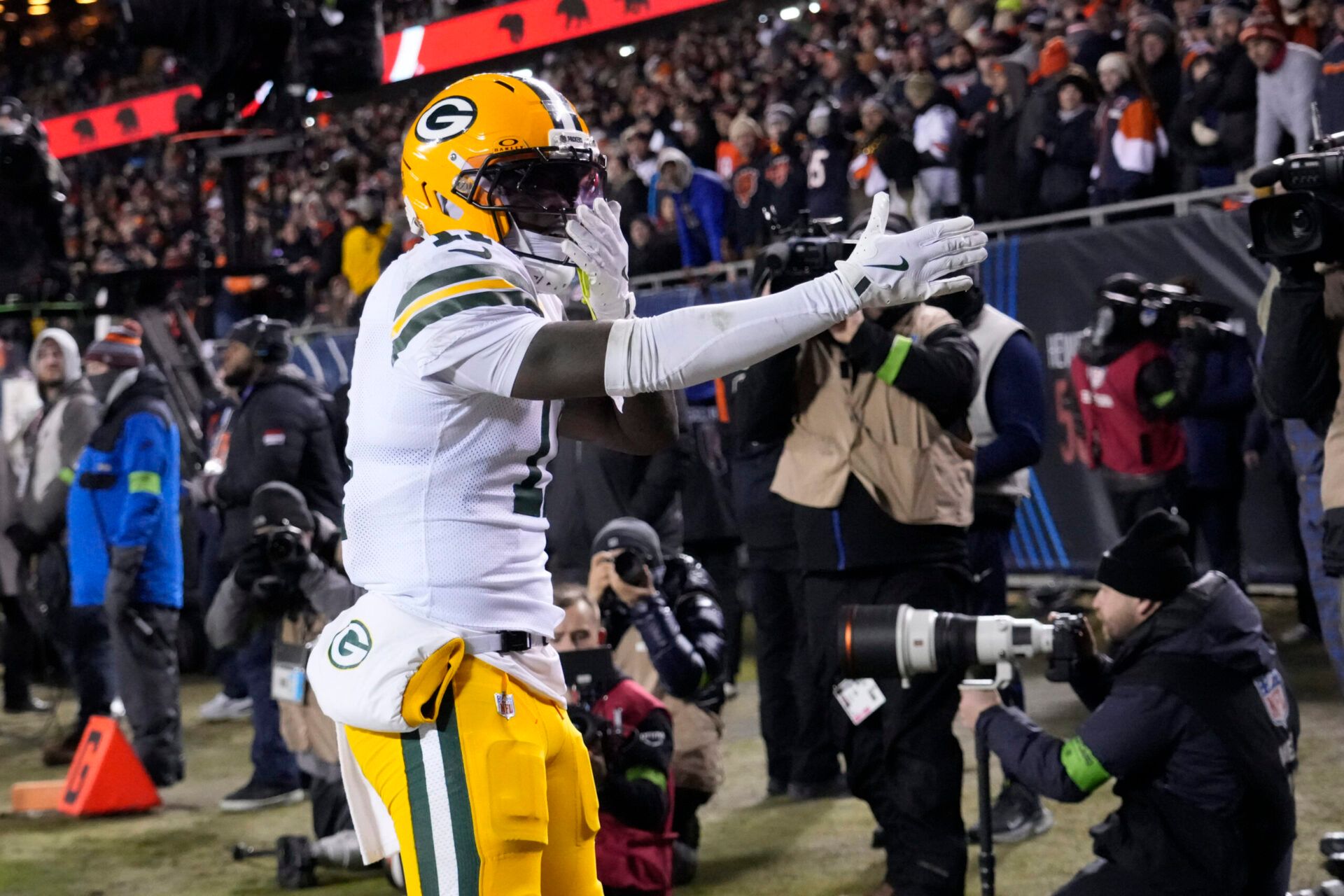 Green Bay Packers wide receiver Jayden Reed (11) reacts after scoring touchdown against the Chicago Bears during the first half of an NFC Wild Card Round game at Soldier Field.