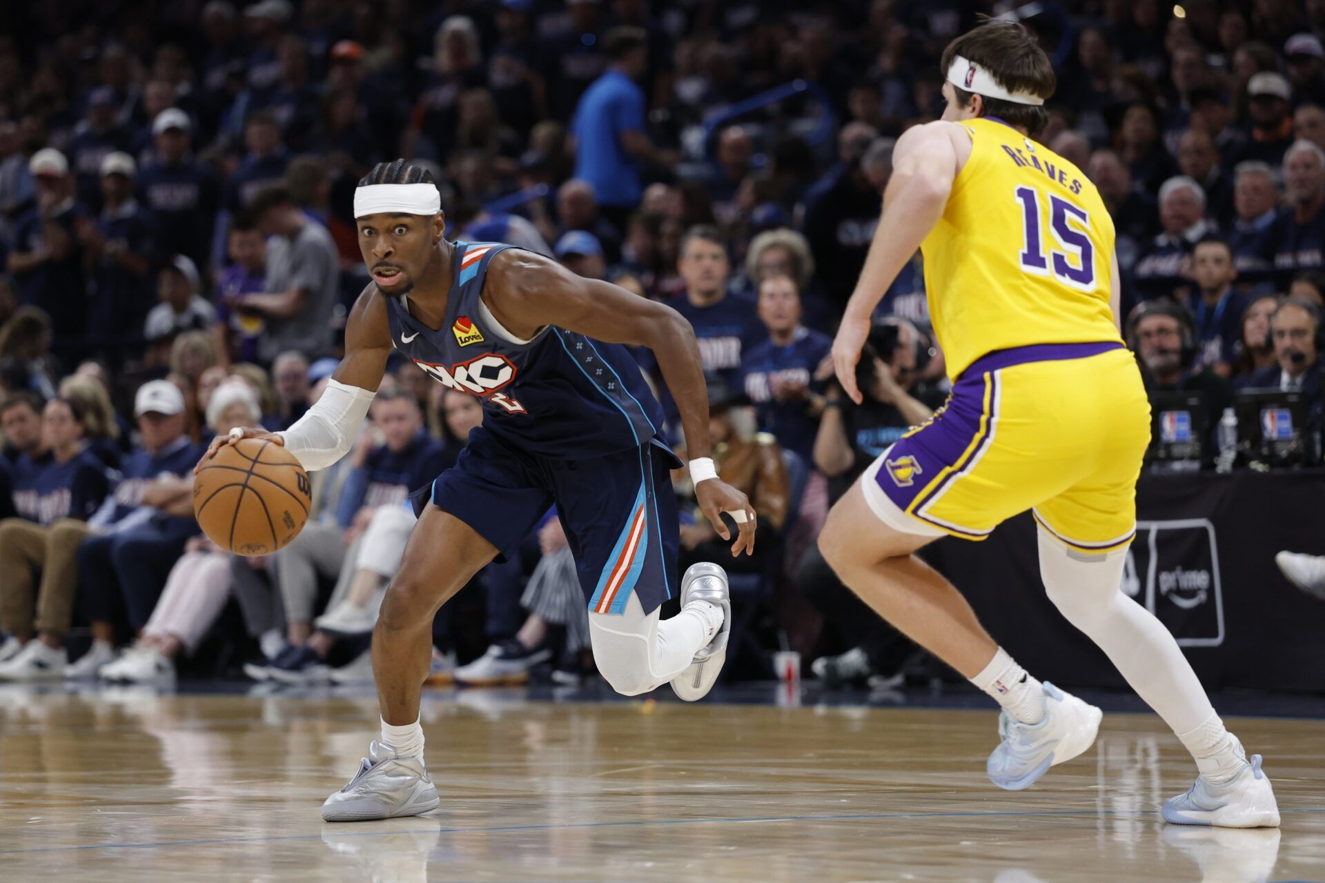 Oklahoma City Thunder guard Shai Gilgeous-Alexander (2) drives down the court against Los Angeles Lakers guard Austin Reaves (15) in the second half during game two of the second round of the 2026 NBA Playoffs at Paycom Center.