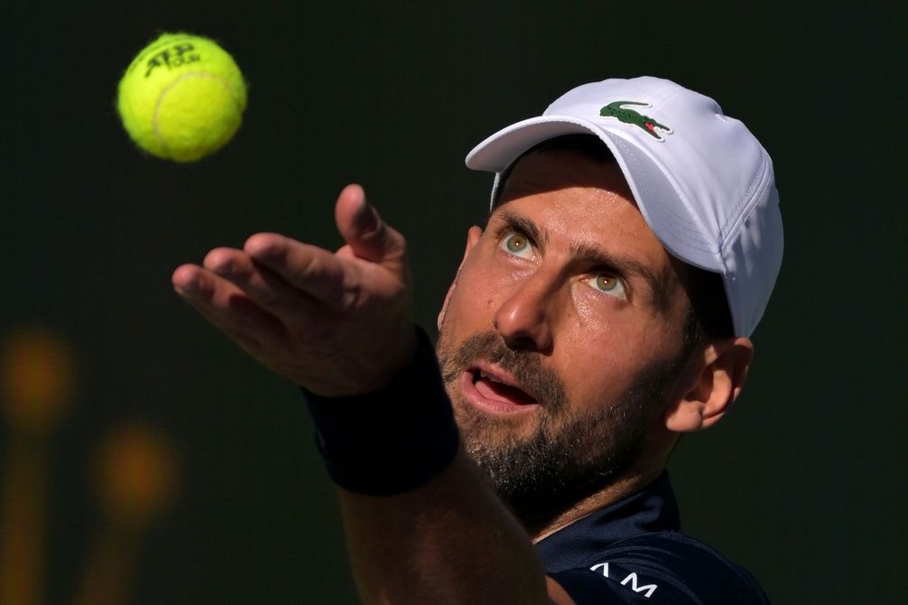 Novak Djokovic (SRB) tosses the ball for a serve during his second round match against Kamil Majchrzak (POL) in the BNP Paribas Open at the Indian Wells Tennis Garden.