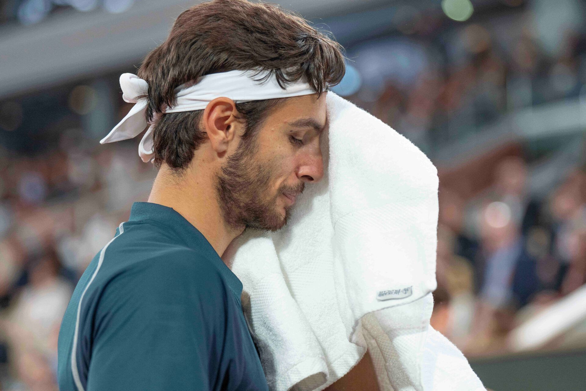 Lorenzo Musetti of Italy reacts to a point during his match against Carlos Alcaraz of Spain match on day 13 at Roland Garros Stadium.