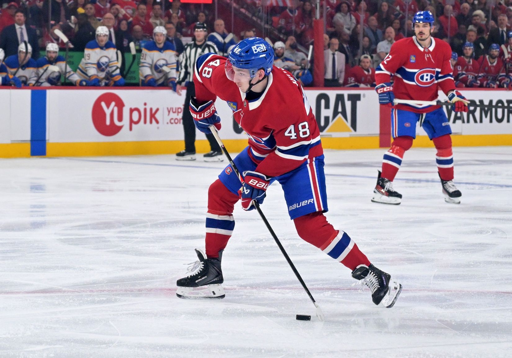 Montreal Canadiens defenseman Lane Hutson (48) plays the puck against the Buffalo Sabres during the third period in game three of the second round of the 2026 Stanley Cup Playoffs at the Bell Centre.