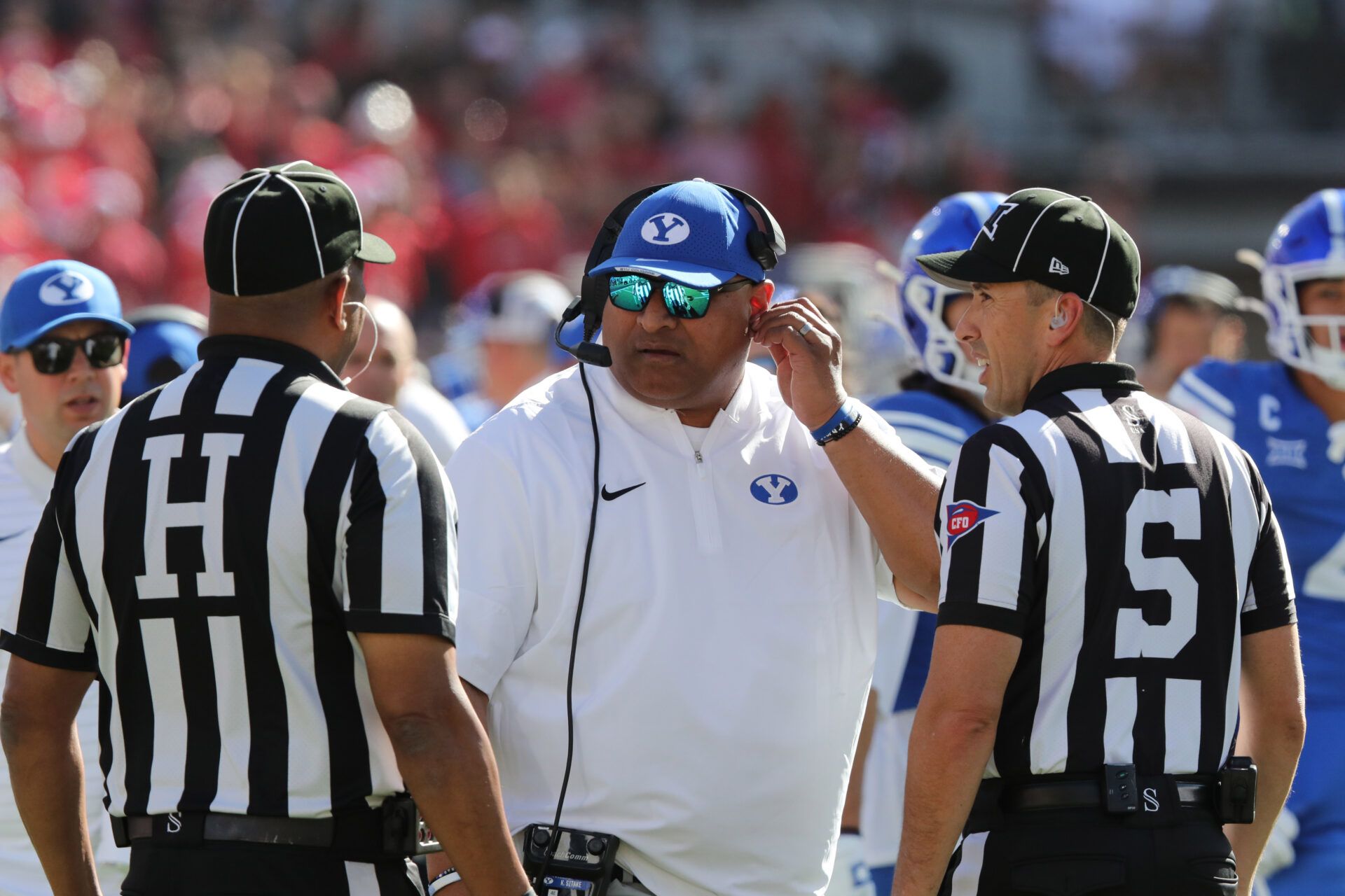 Brigham Young Cougars head coach Kalani Sitake discusses a call with Big 12 official Bradford Edwards and official Randy Smith in the second half of the game against the Texas Tech Red Raiders at Jones AT&T Stadium.