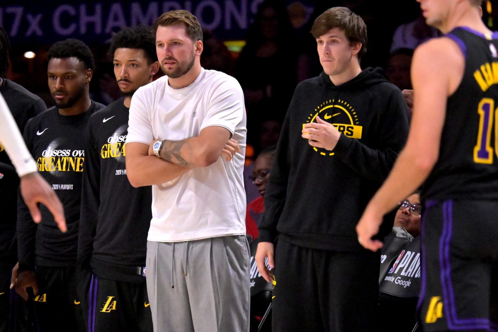 Los Angeles Lakers guard Luka Doncic (77) and guard Austin Reaves (15) look on from the bench during the second half of game two of the first round of the 2026 NBA Playoffs against the Houston Rockets at Crypto.com Arena.