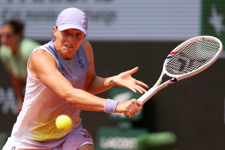 Iga Swiatek of Poland returns a shot during her match against Elina Svitolina of Ukraine on day 10 at Roland Garros Stadium.