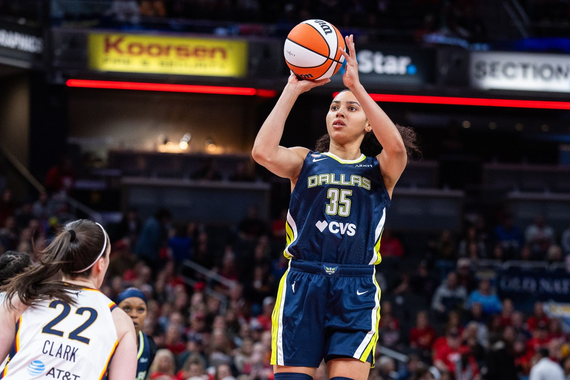 Dallas Wings guard Azzi Fudd (35) shoots the ball while Indiana Fever guard Caitlin Clark (22) defends in the first half at the Gainbridge Fieldhouse.