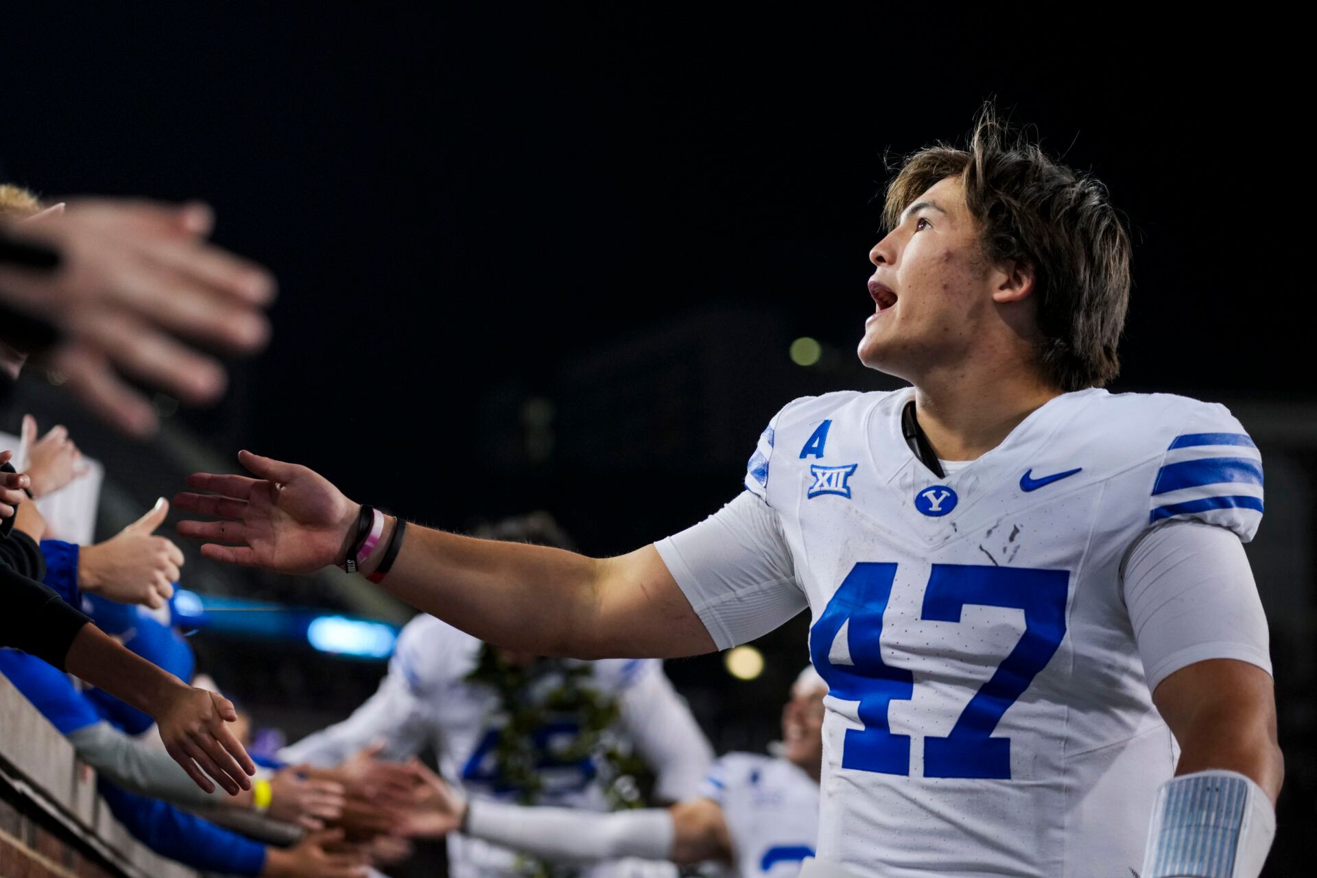 BYU Cougars quarterback Bear Bachmeier celebrates with fans after defeating the Cincinnati Bearcats at Nippert Stadium.