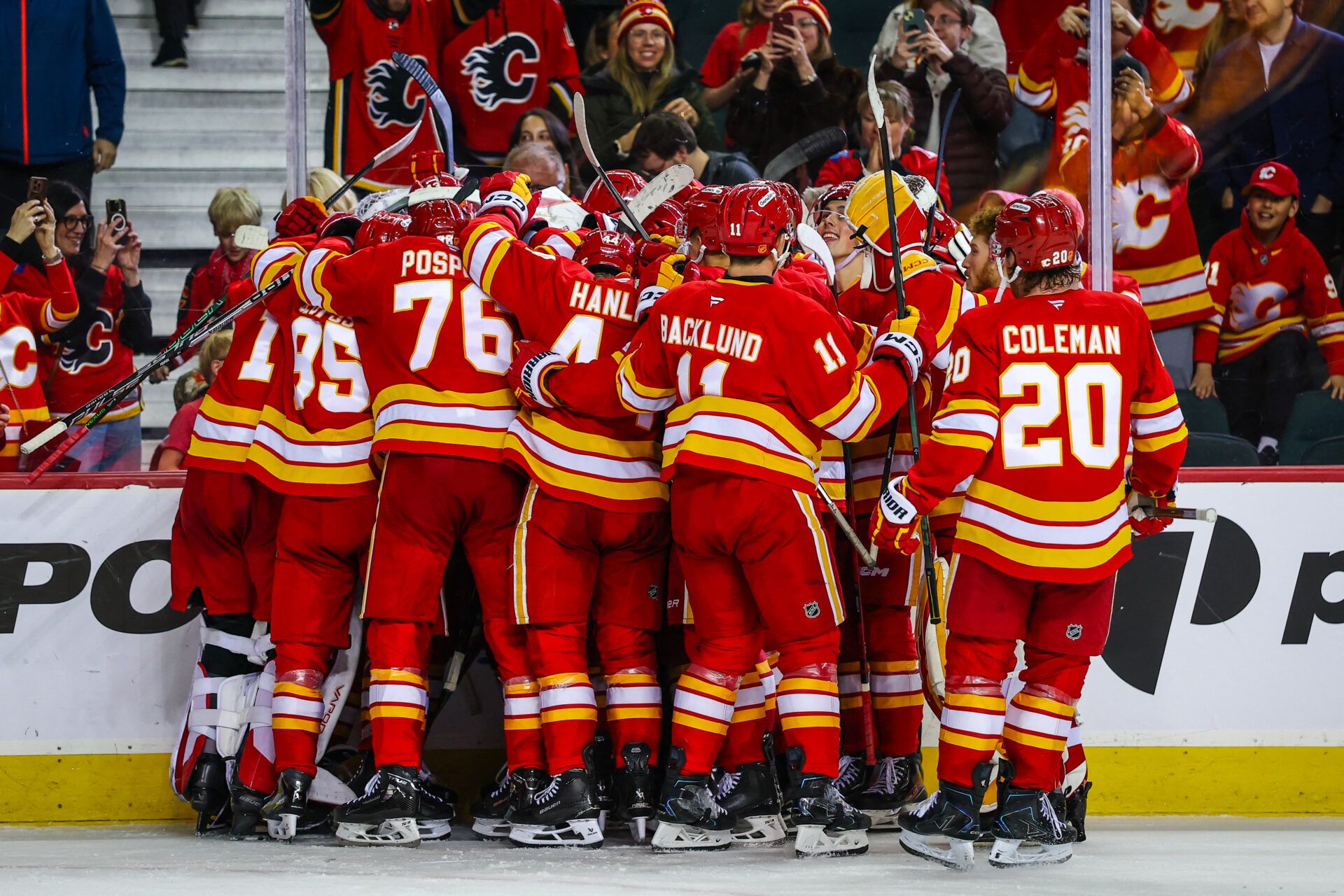 Calgary Flames players celebrate win with teammates at Scotiabank Saddledome.