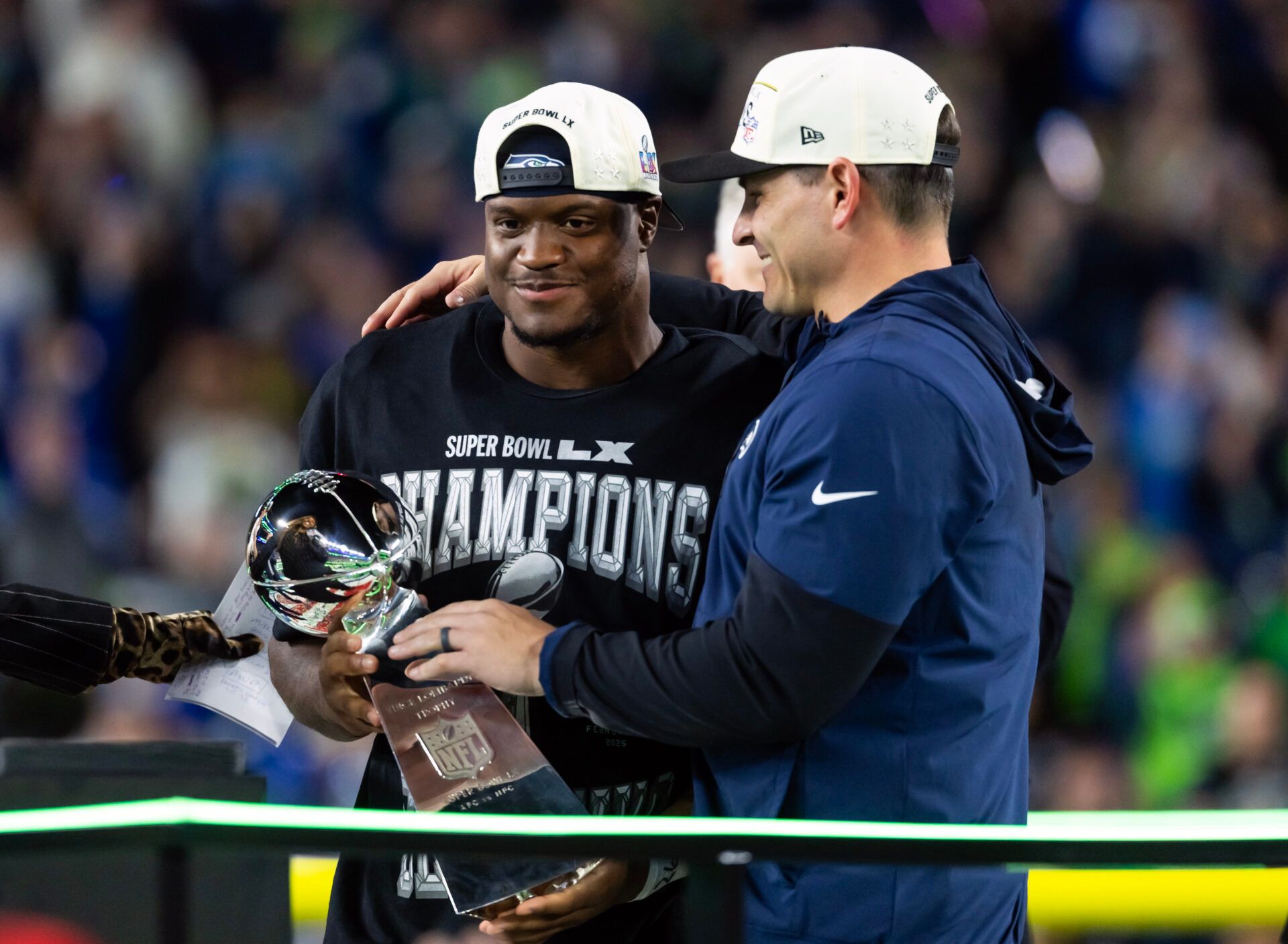 Seattle Seahawks head coach Mike MacDonald and running back Kenneth Walker III (9) celebrate with the Vince Lombardi trophy after defeating the New England Patriots in Super Bowl LX at Levi's Stadium.