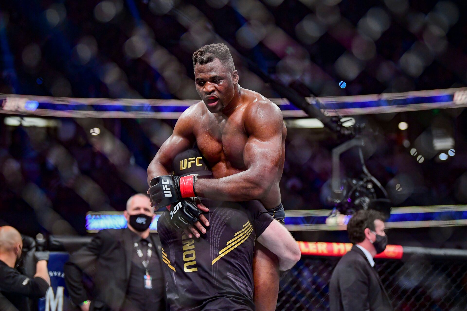 Francis Ngannou (red gloves) celebrates after the fight against Ciryl Gane (blue gloves) during UFC 270 at Honda Center.