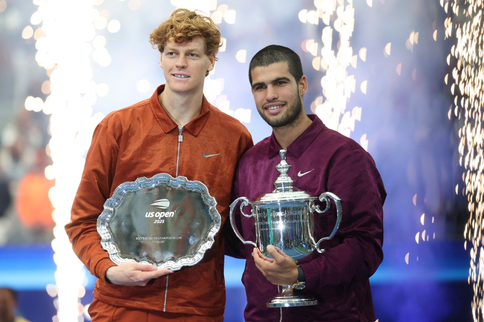 Carlos Alcaraz (ESP) and Jannik Sinner (ITA) pose with their trophies after the final of mens singles at Billie Jean King National Tennis Center.