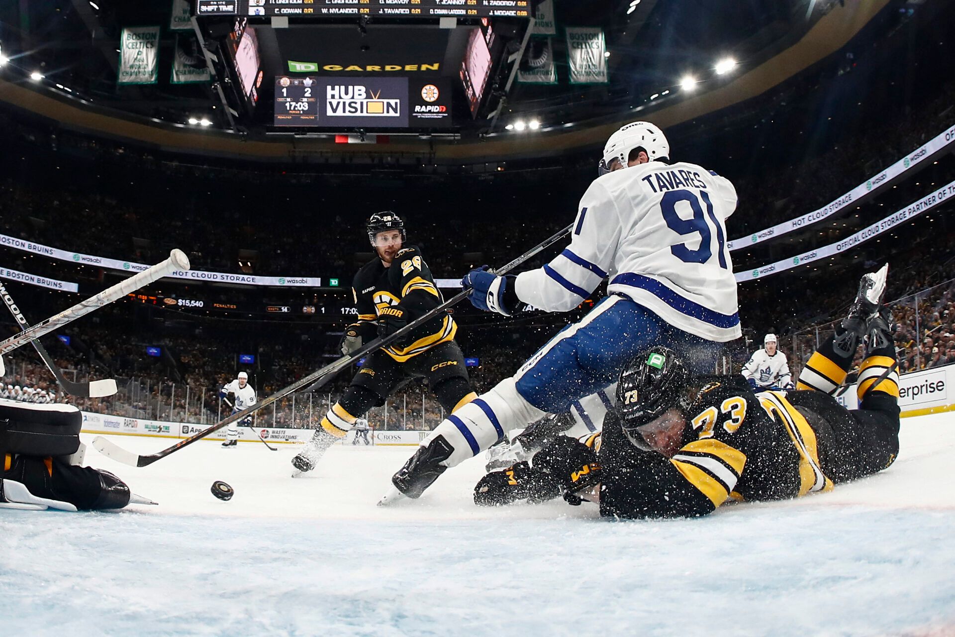 Boston Bruins defenseman Charlie McAvoy (73) takes out Toronto Maple Leafs center John Tavares (91) at TD Garden.
