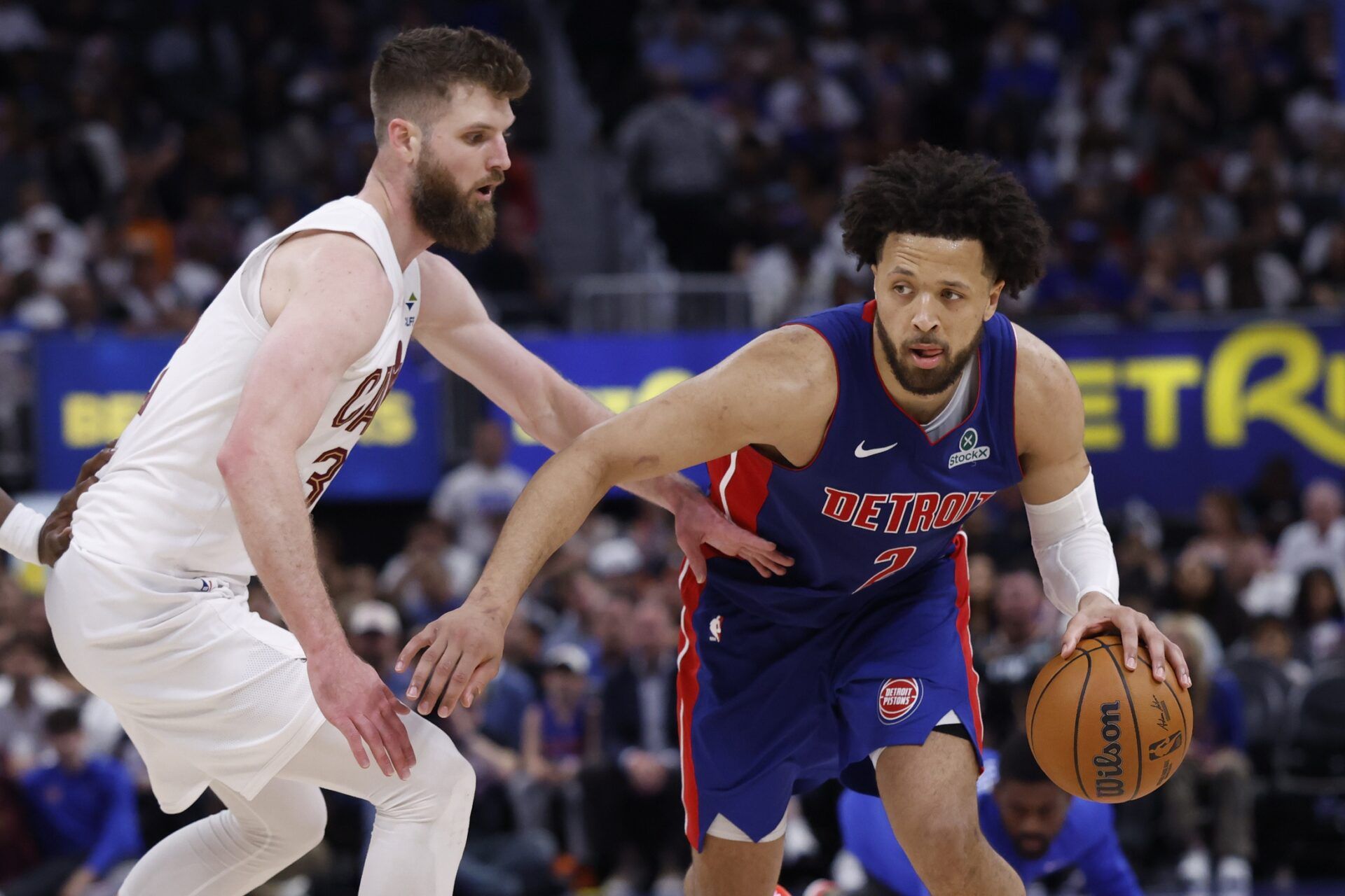 Detroit Pistons guard Cade Cunningham (2) dribbles against Cleveland Cavaliers forward/center Dean Wade (32) in the second half during game seven of the second round of the 2026 NBA Playoffs at Little Caesars Arena.