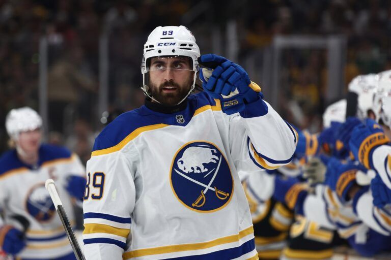 Buffalo Sabres right wing Alex Tuch (89) points to his goaltender after being congratulated at the bench after scoring against the Boston Bruins during the first period of game six of the first round of the 2026 Stanley Cup Playoffs at TD Garden.