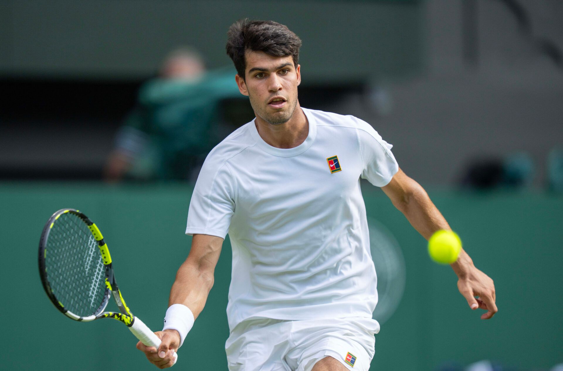 Carlos Alcaraz of Spain returns a shot during the menÕs singles final match against Jannik Sinner of Italy on day 14 at All England Lawn Tennis and Croquet Club.