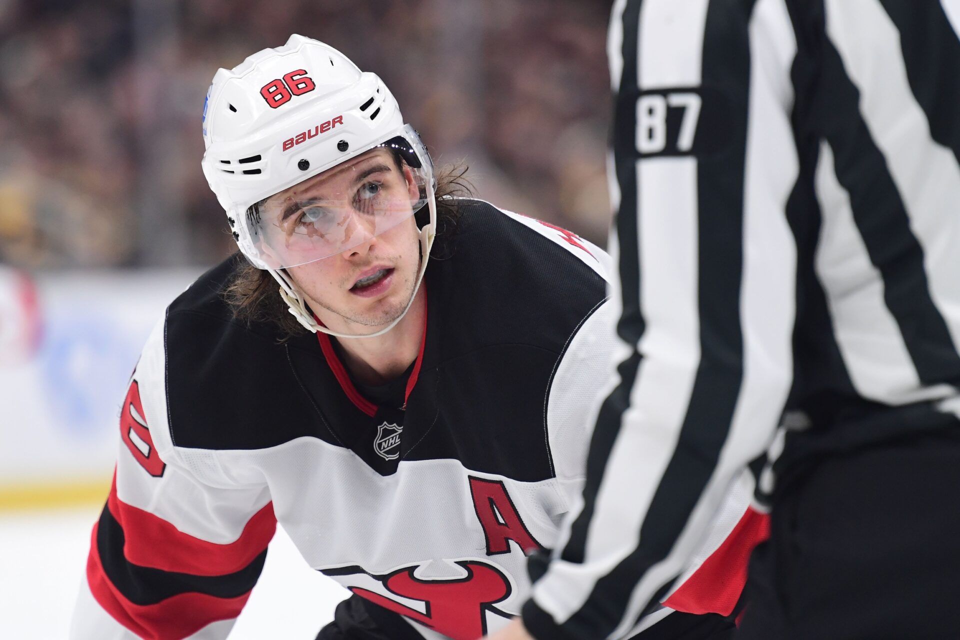 New Jersey Devils center Jack Hughes (86) looks at the linesman before a face-off during the second period against the Boston Bruins at TD Garden.