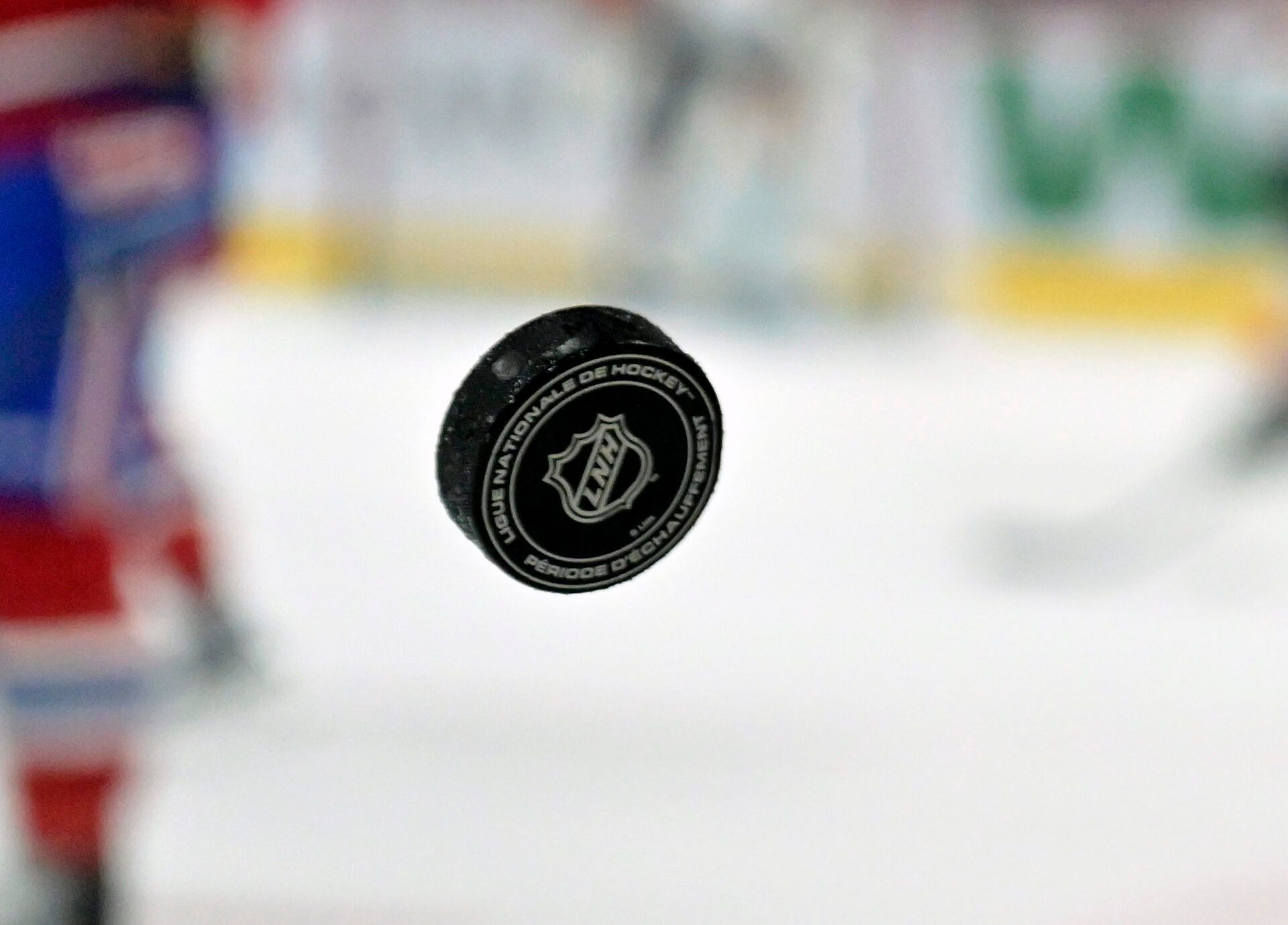 French logo on an NHL puck during the warmup period before the game between the Philadelphia Flyers and the Montreal Canadiens at the Bell Centre.