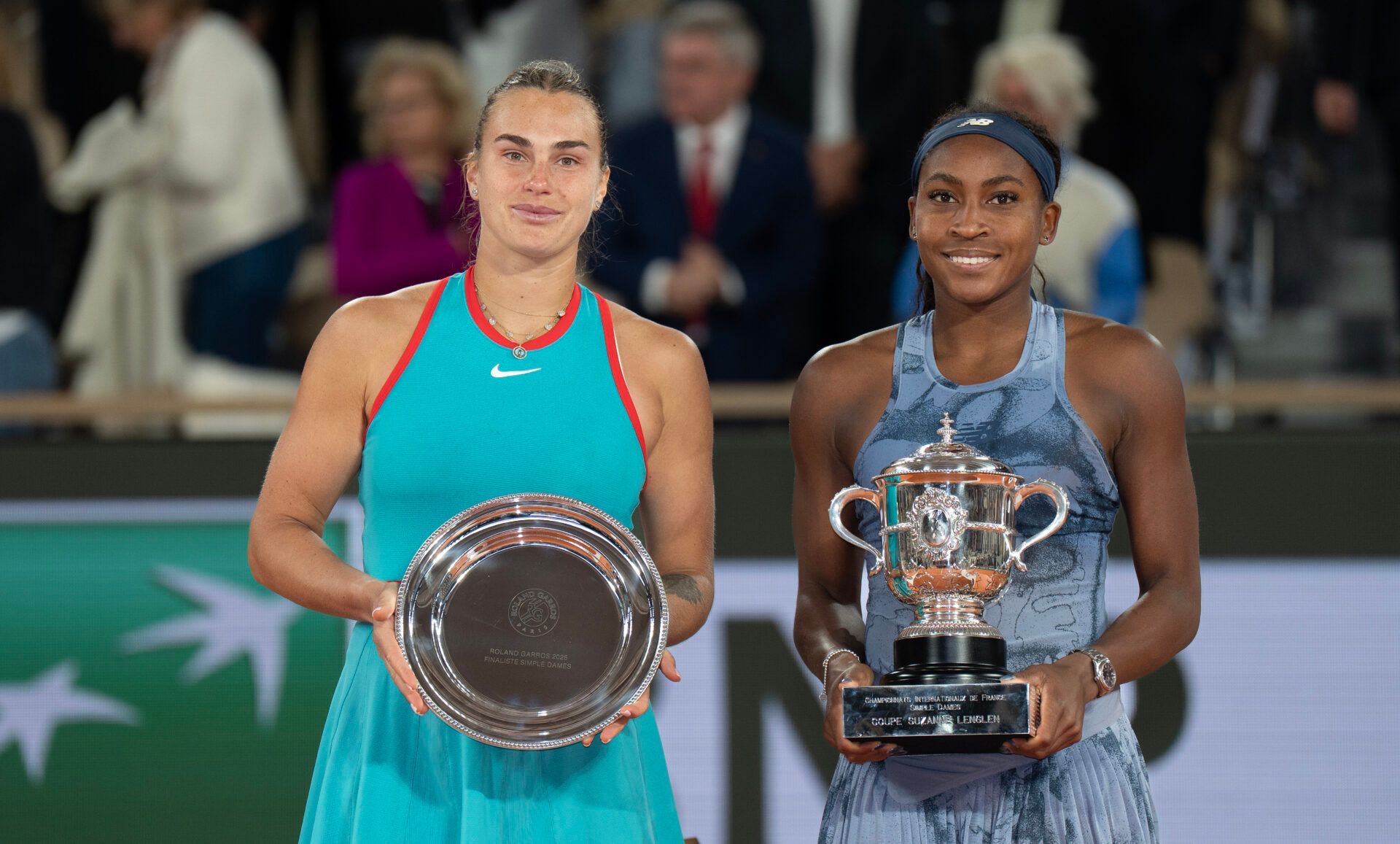 Coco Gauff of the United States poses with Aryna Sabalenka after their match on day 14 at Roland Garros Stadium.
