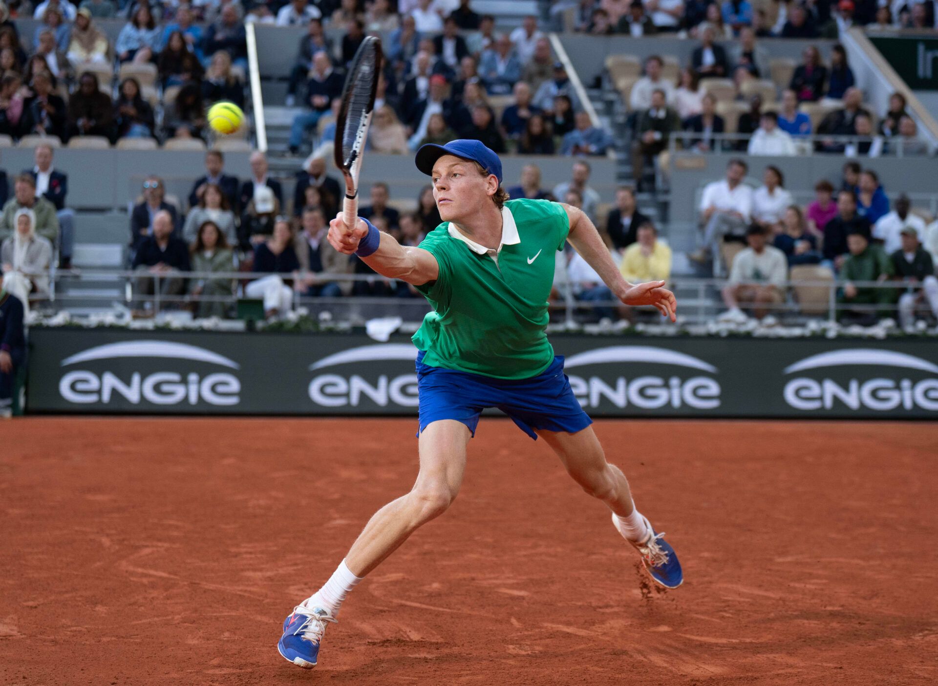 Jannik Sinner of Italy returns a shot during his match against Novak Djokovic of Serbia on day 13 at Roland Garros Stadium.
