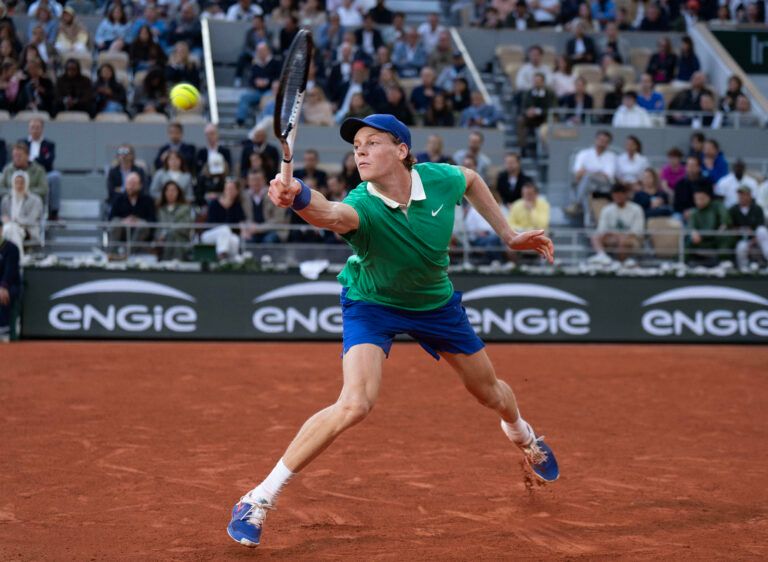 Jannik Sinner of Italy returns a shot during his match against Novak Djokovic of Serbia on day 13 at Roland Garros Stadium.