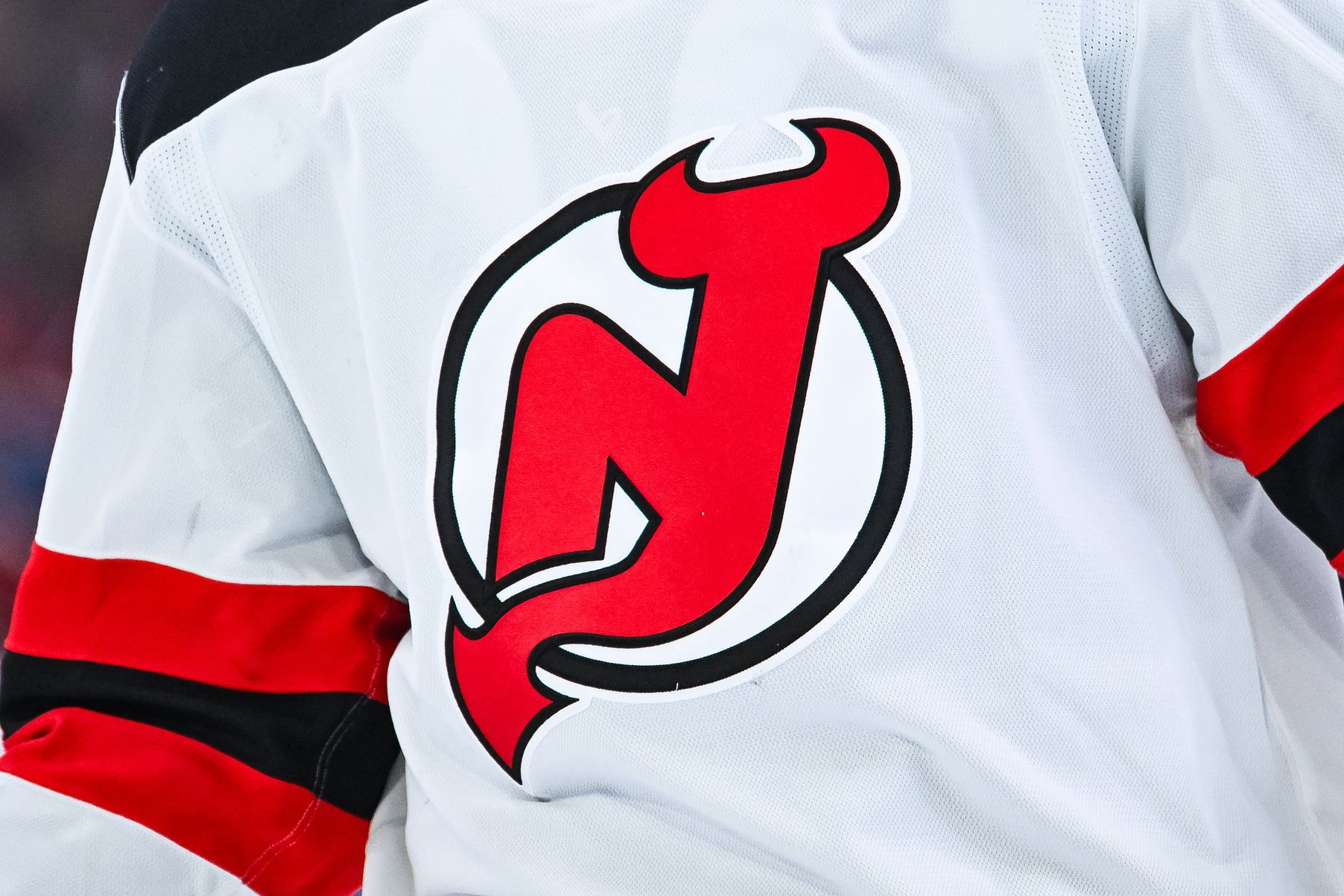 View of a New Jersey Devils logo on a jersey worn by a member of the team during the second period at Bell Centre.