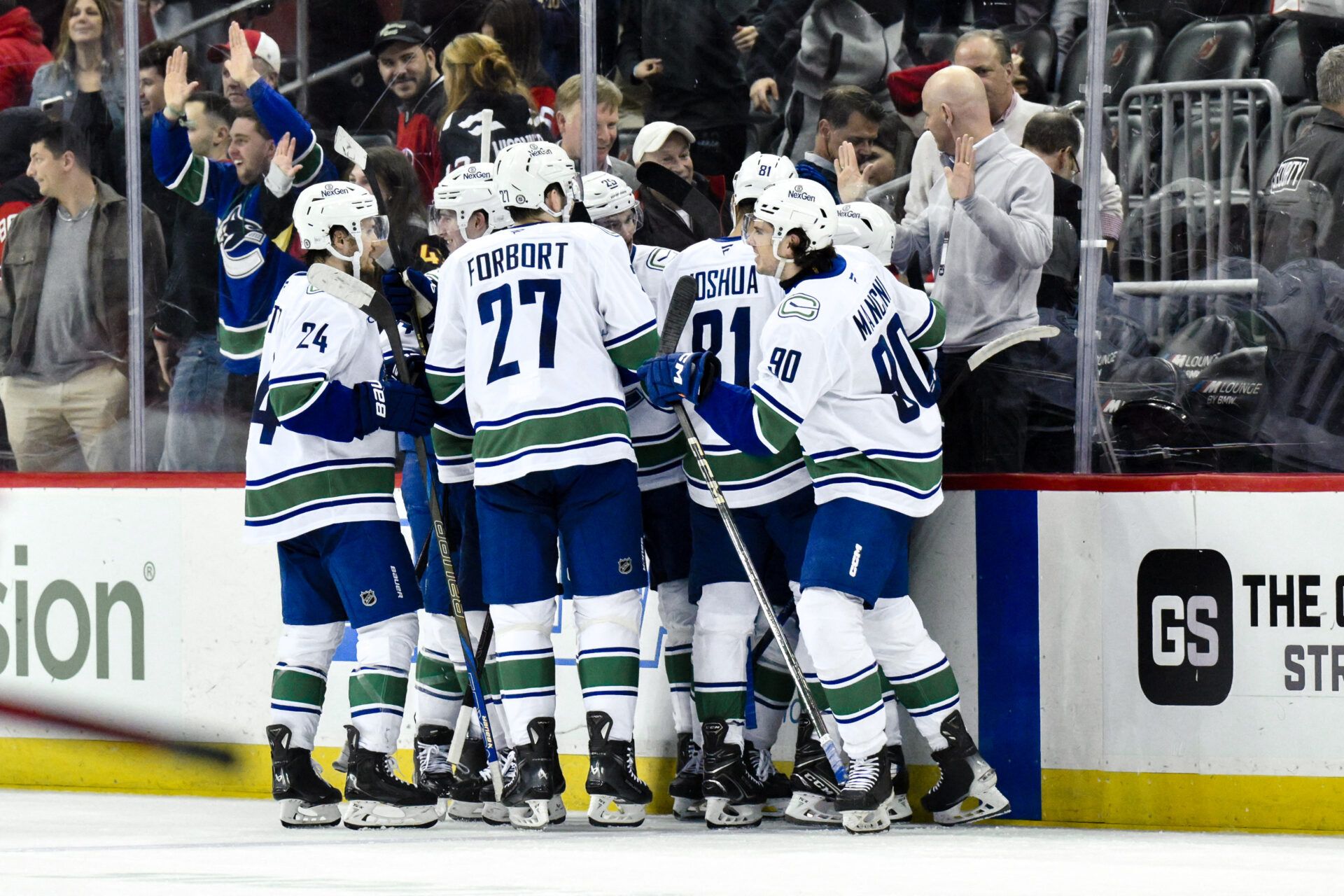 Vancouver Canucks players celebrate at Prudential Center.