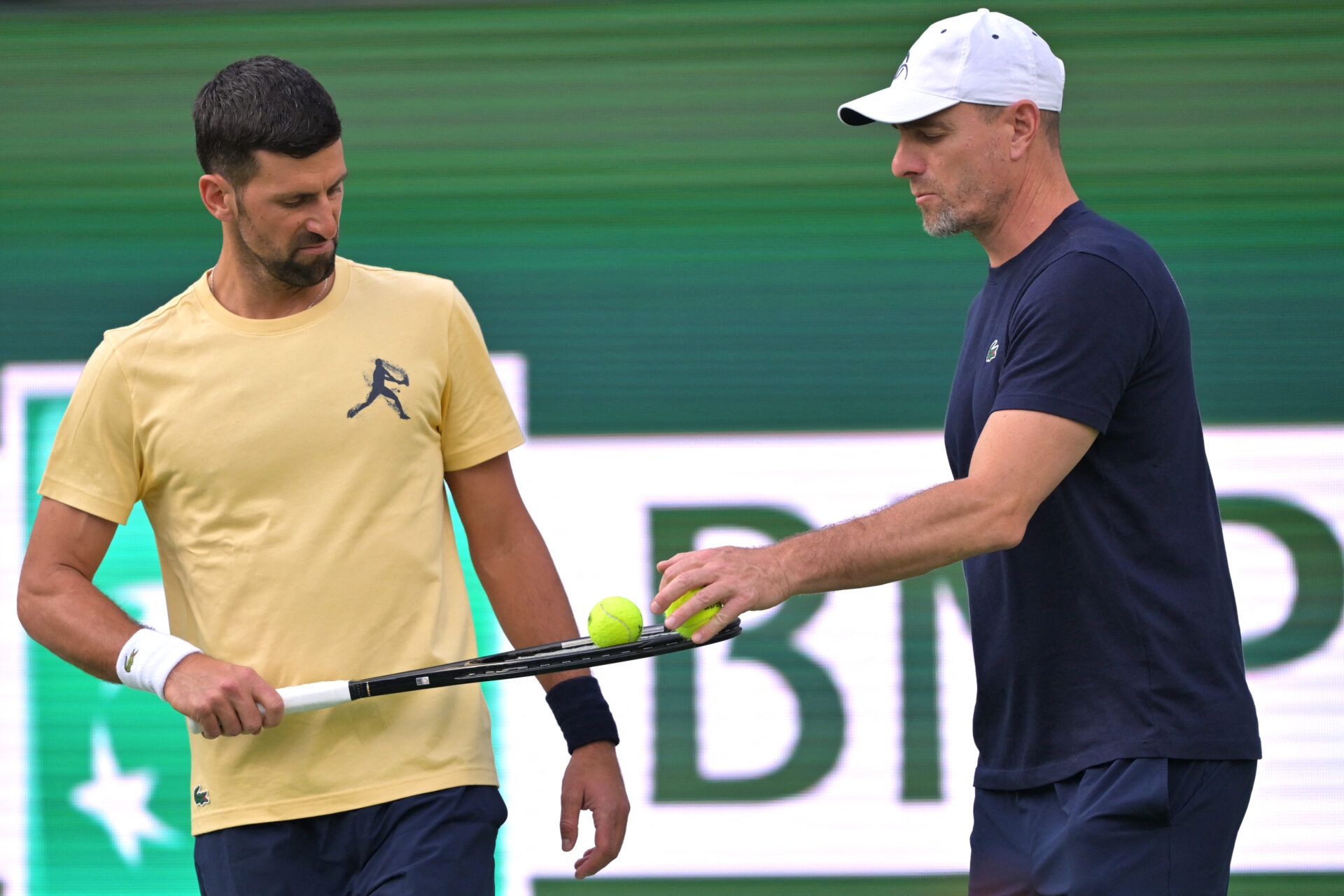 Novak Djokovic (SRB), left, with his coach Boris Bosnjakovic during his practice session for the BNP Paribas Open at the Indian Wells Tennis Garden.