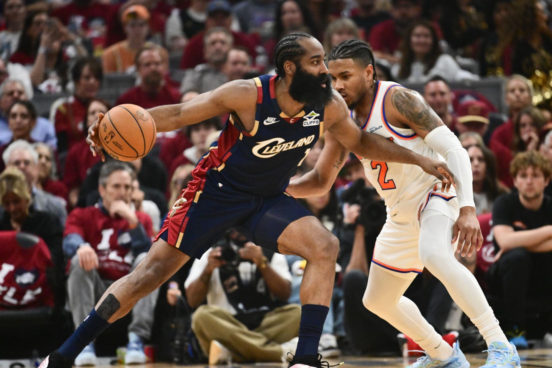 Cleveland Cavaliers guard James Harden (1) moves the ball while defended by New York Knicks guard Miles McBride (2) in the second quarter during game four of the eastern conference finals for the 2026 NBA playoffs at Rocket Arena.