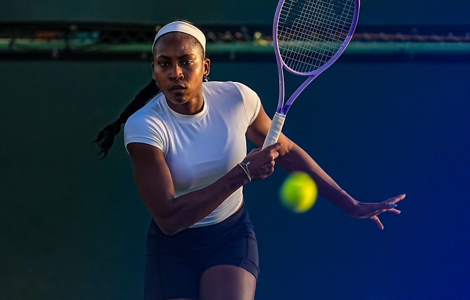 Coco Gauff returns a ball during practice with Leylah Fernandez