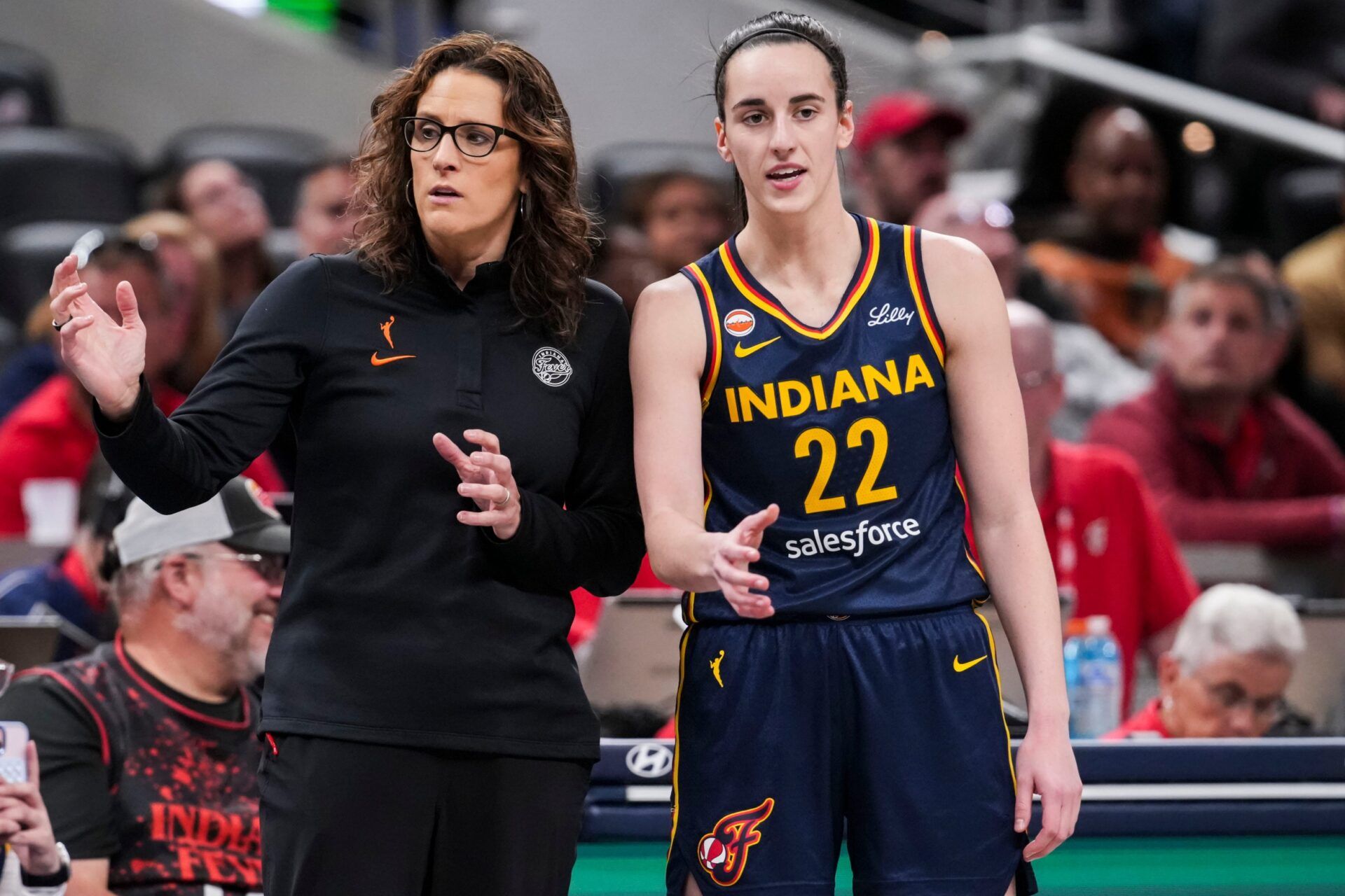 Indiana Fever head coach Stephanie White talks with Indiana Fever guard Caitlin Clark (22) on Saturday, May 2, 2026, during the first half of a preseason game at Gainbridge Fieldhouse in Indianapolis.