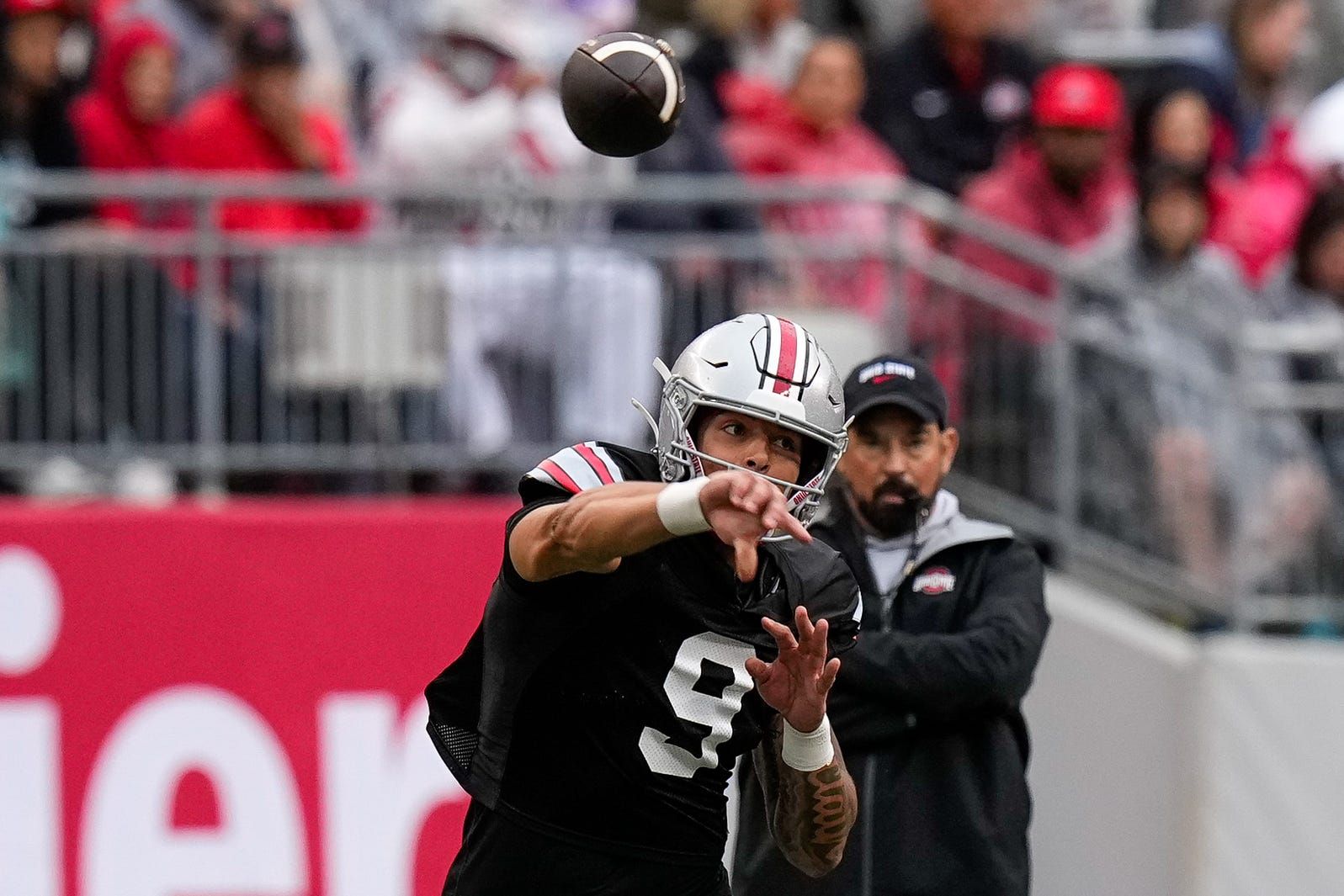 Quarterback Tavien St. Clair (9) makes a pass as head coach Ryan Day watches in the background in the second half of the Ohio State football spring game at Ohio Stadium on Saturday, April 18, 2026 in Columbus, Ohio.