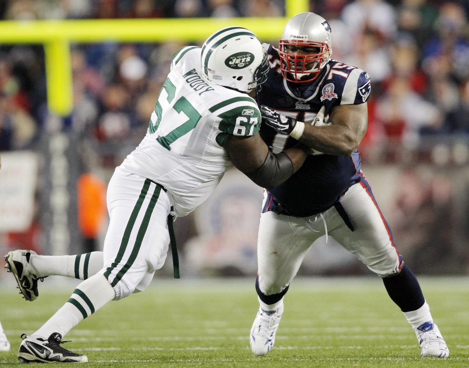 New England Patriots defensive tackle Vince Wilfork (75) defends against New York Jets offensive tackle Damien Woody (67) during the second quarter at Gillette Stadium. The Patriots defeated the Jets 31-14.