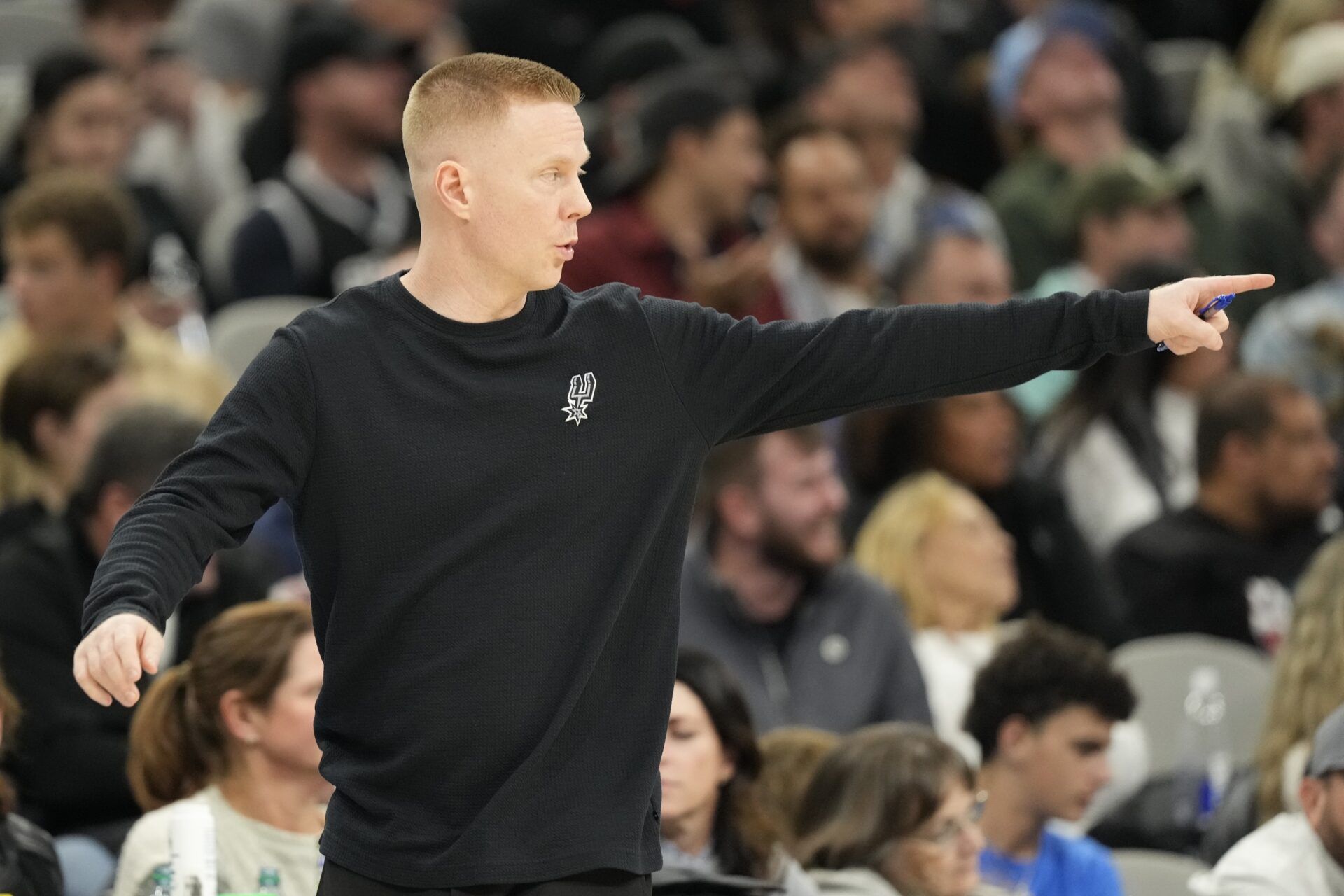 San Antonio Spurs assistant head coach Sean Sweeney signals to players during the second half against the Memphis Grizzlies at Frost Bank Center.