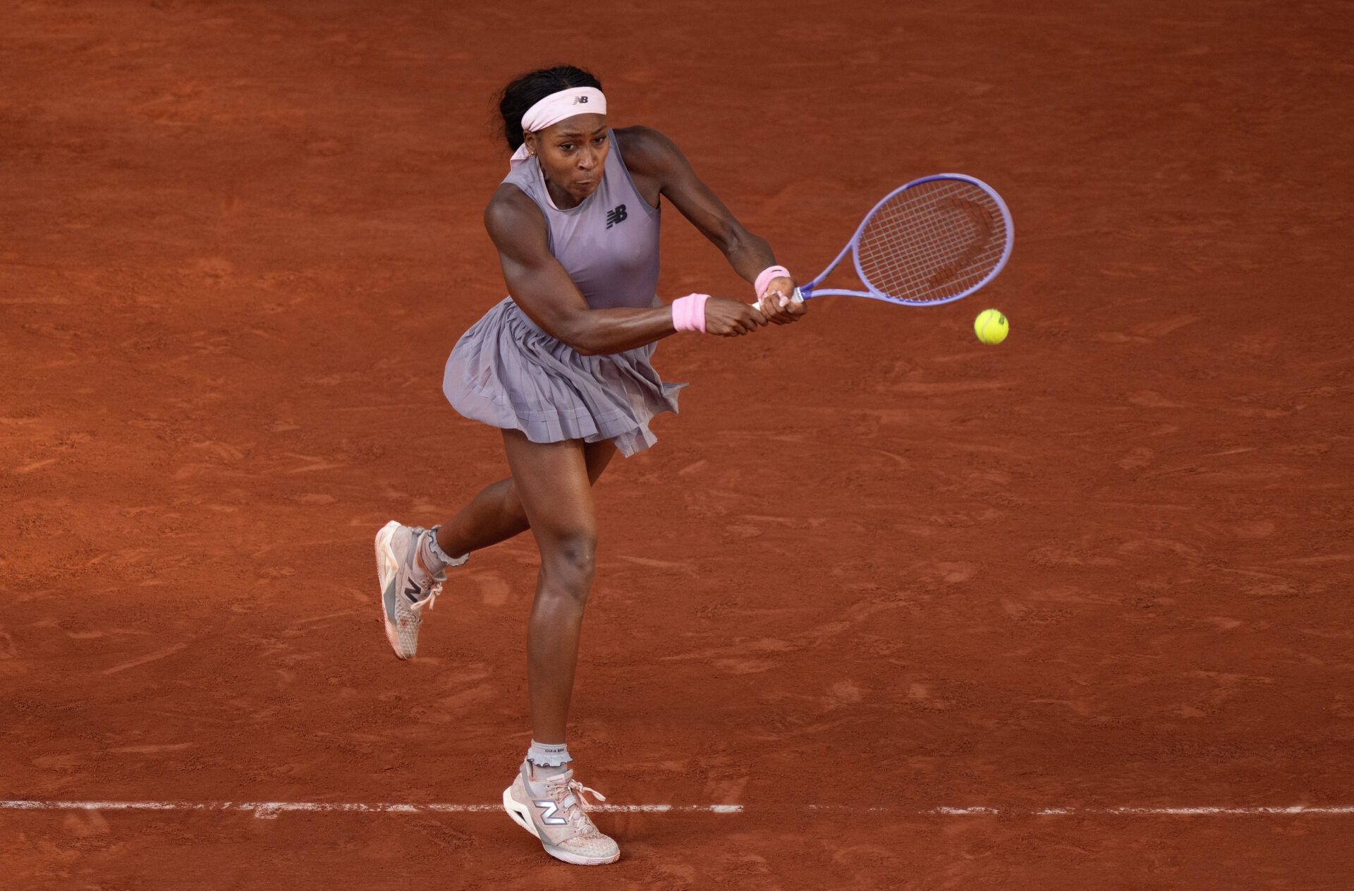Coco Gauff of the United States returns a shot during her match against Anastasia Potapova of Austria on day seven at Stade Roland Garros.