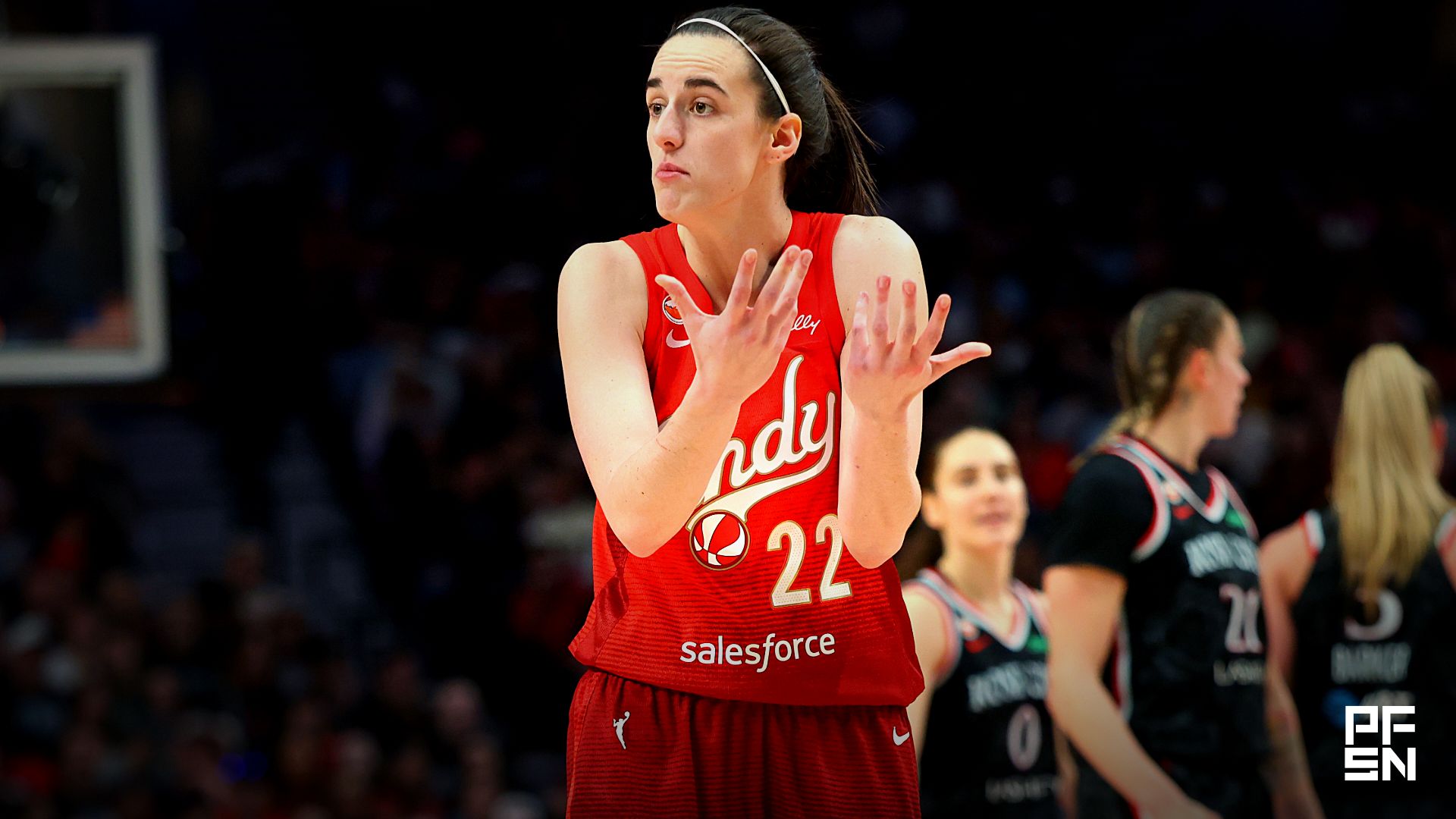 Indiana Fever guard Caitlin Clark (22) chats with a referee during the second half against the Portland Fire at Moda Center.