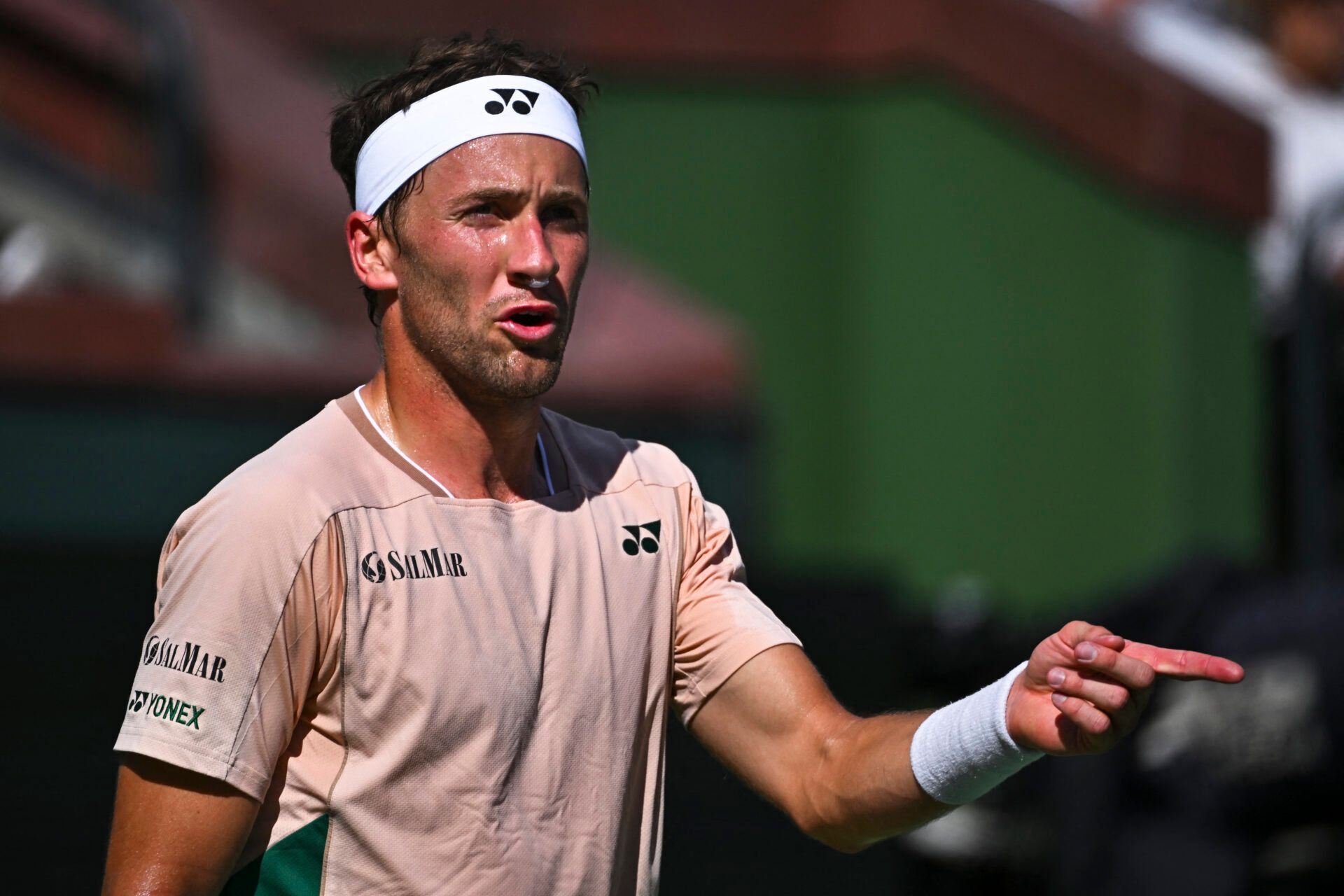 Casper Ruud (NOR) points out distractions to the umpire against Marcos Giron (USA) at Indian Well Tennis Garden.