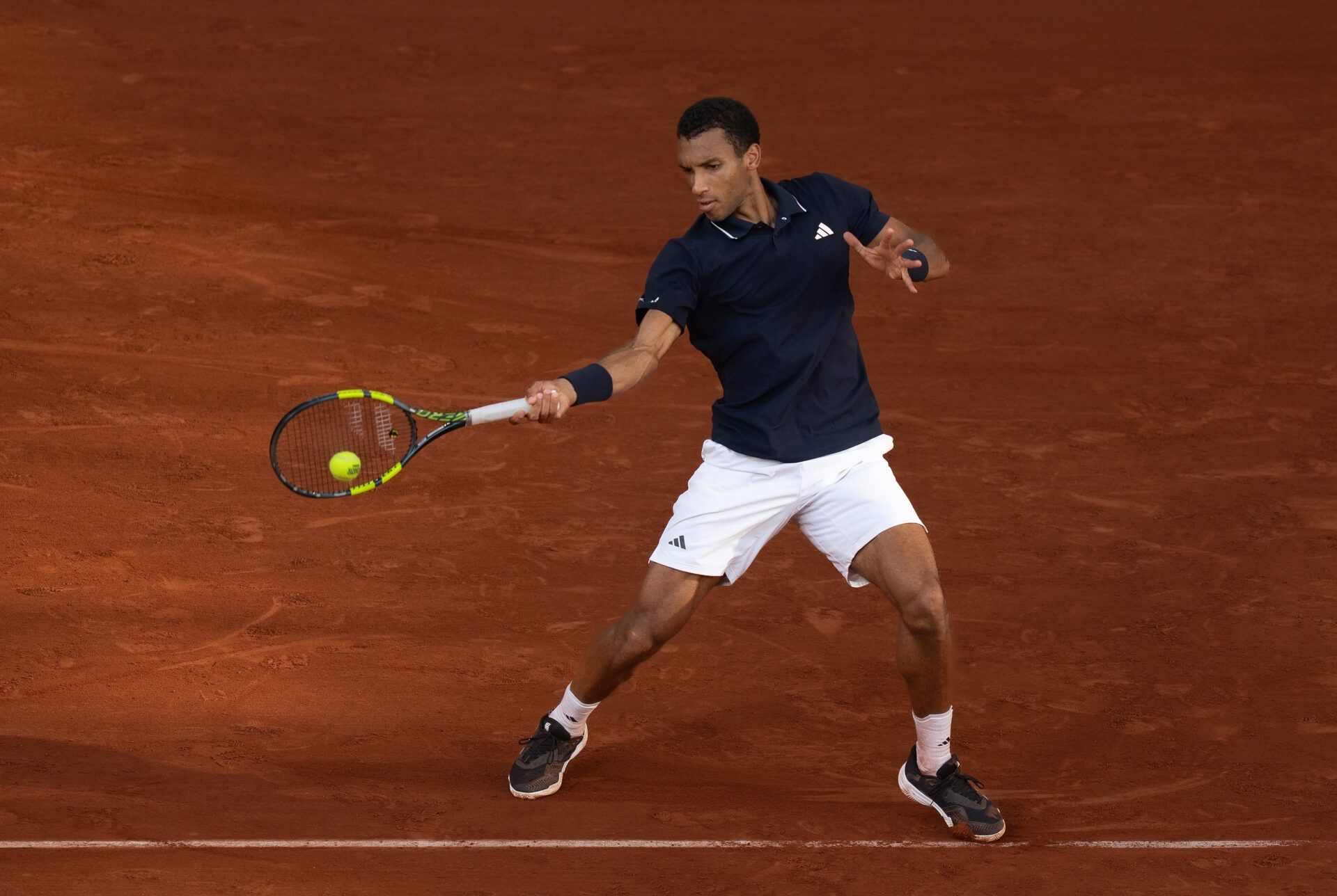 Felix Auger-Aliassime of Canada returns a shot during his match against Alejandro Tabilo of Chile on day nine at Stade Roland Garros.